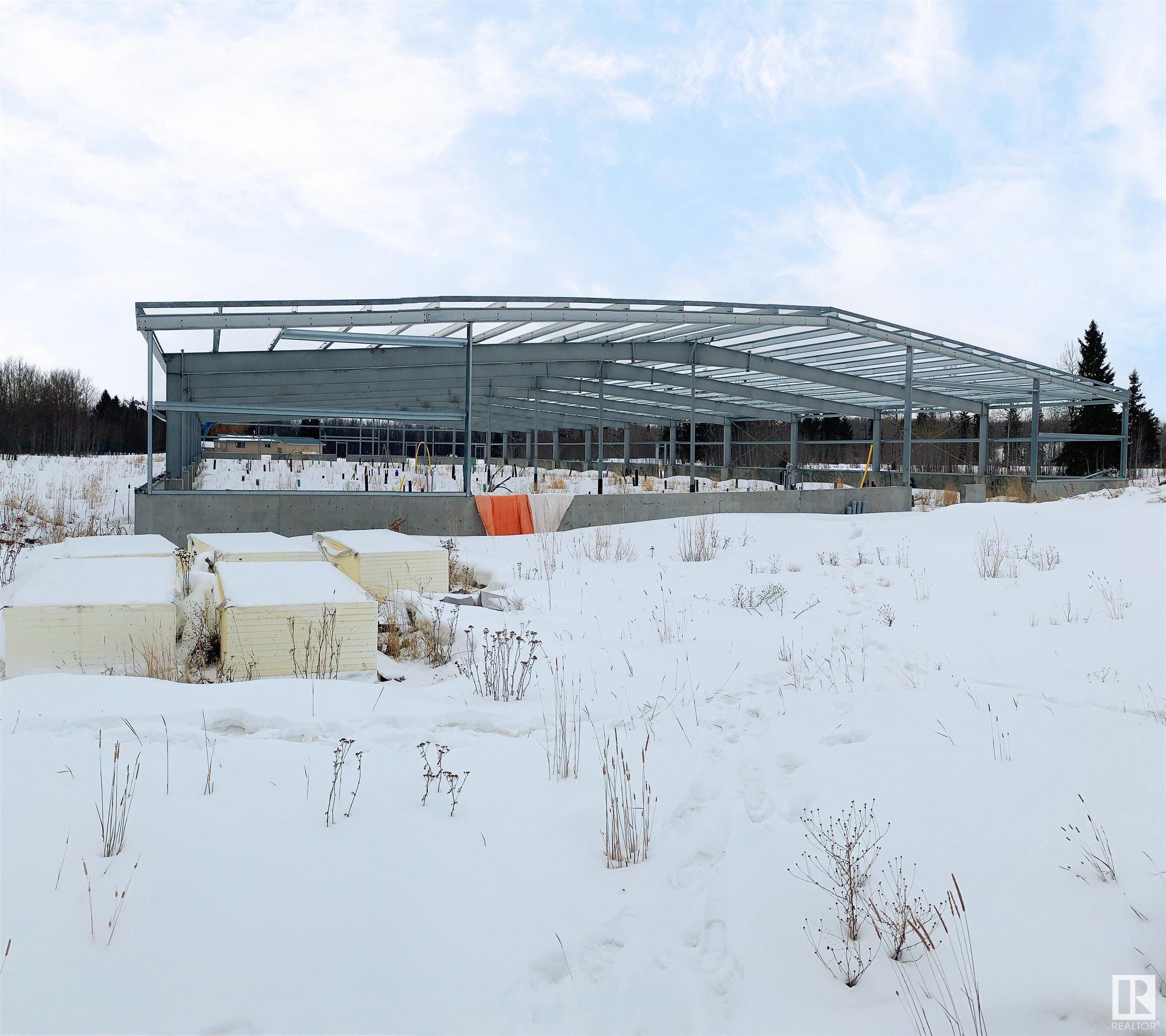 Serviced land parcel with partially developed production facility ? Property currently demised as follows: 22,012 sq.ft. steel frame building on 2.73 acres with services intended for a cannabis cultivation or food production upon completion ? Excess land of 76.27 acres ? All building plans and transferable permits included as part of the sale ? Located just off HWY 16, North of Wabamun Lake and ~40 minutes from Edmonton city limits ? Water well and an unquantified amount of gravel material to the excess land point