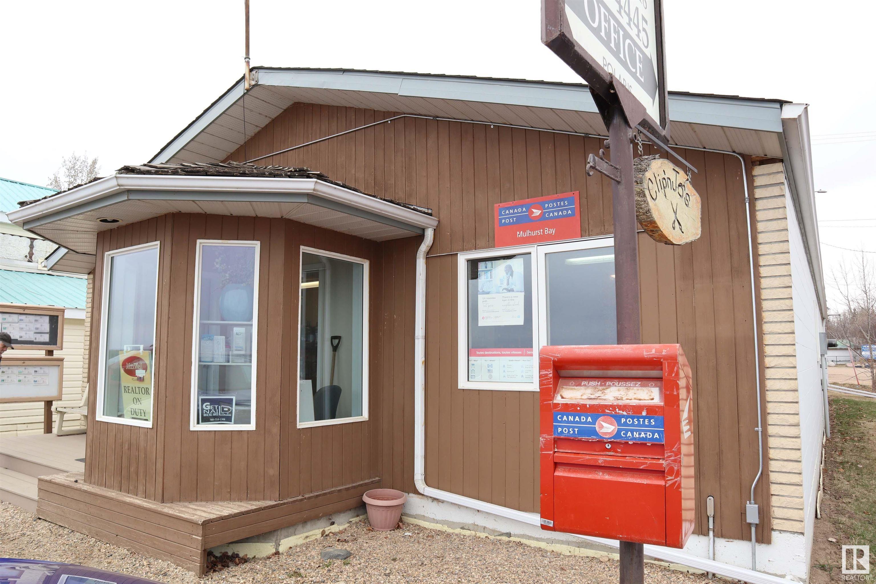 Located on Lake Drive at Mulhurst Bay, overlooking Pigeon Lake.  2029 sq. ft. retail building built in 1994.   Features 200 amp electrical, cement block walls on sides, cement foundation, wood frame construction front and back, asphalt shingles.  Services include drilled well, municipal sewer, power, natural gas.  Two 2 piece bathrooms, two offices, board room, lunch room with sink, fridge, microwave.  Current renters are Canada Post, Real Estate office, massage therapist, hair salon and nail salon.