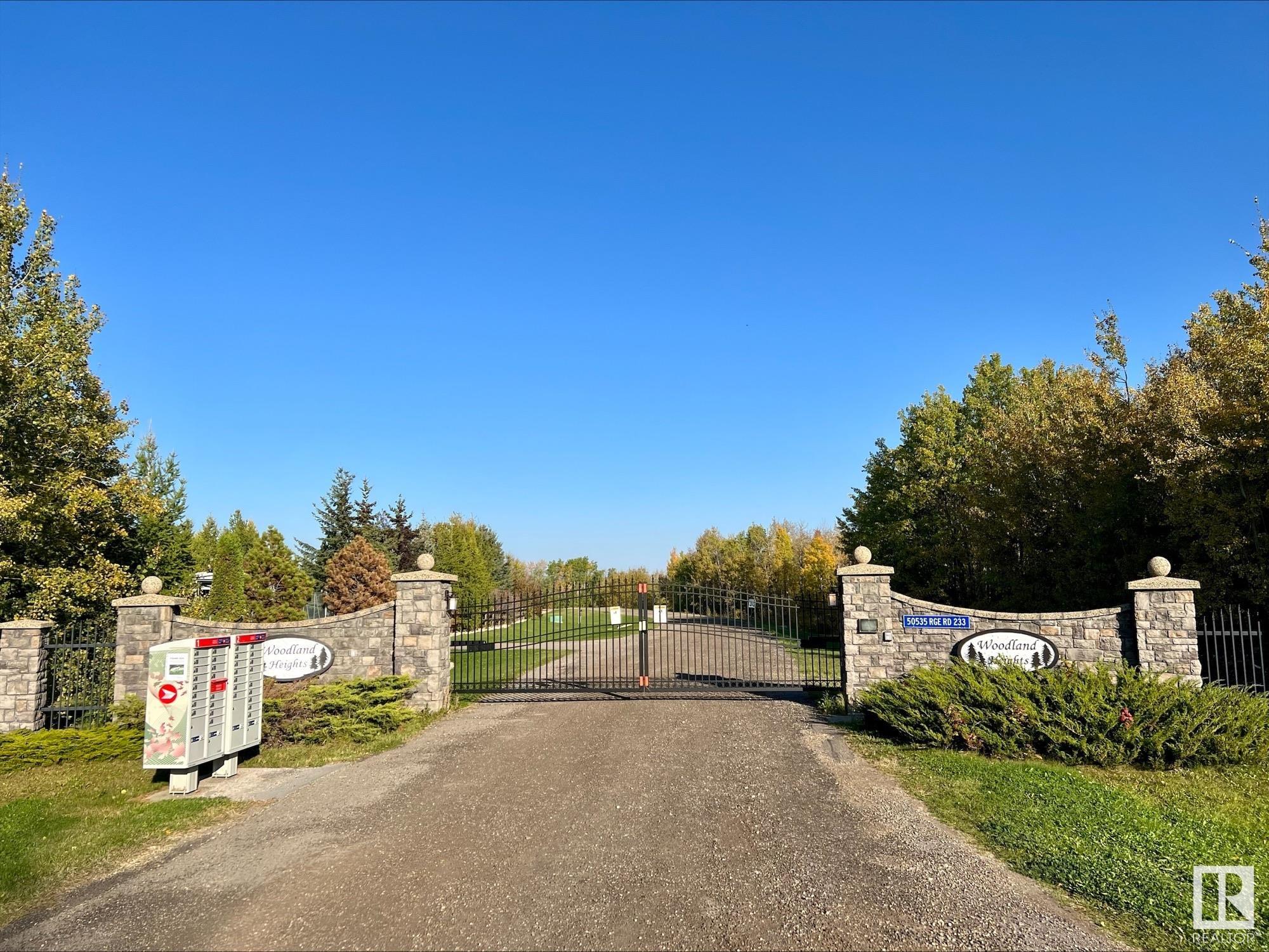 Lovely lot in an upscale ESTATE subdivision WOODLAND HEIGHTS, located just 5 minutes east of Beaumont on Range Road 233. This 2.64 acre parcel is 1/2 TREED in NATURAL FOREST and has west exposure. Build your DREAM HOME up to the trees or nestle it within the treed area, there are a LOT OF CHOICES on a lot this size. $1,915.00 annual condo fee for ROAD AND GATE MAINTENANCE which is common property. 10 minutes to South Edmonton, 15 to Sherwood Park and 15 minutes to the Edmonton International Airport. Children are bussed to Beaumont for school. Cisterns and septic systems approved by Leduc County are the norm for the area. Restrictive Covenants in place to protect your investment, this is COUNTRY LIVING AT ITS FINEST!