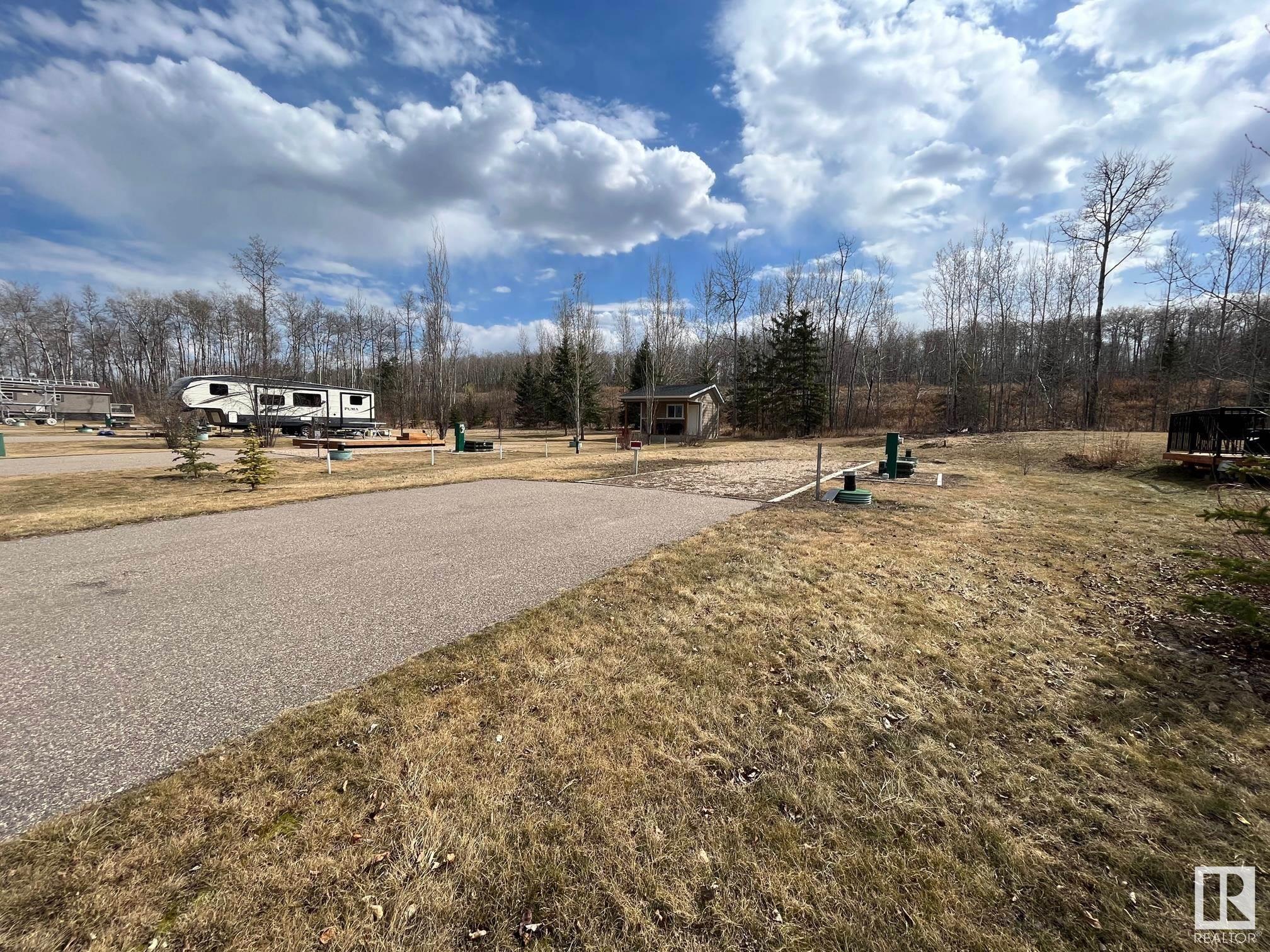Great opportunity to have an RV lot in the Wood Creek Resort located lakefront on Moose Lake! It features a 750 gallon cistern and 750 gallon holding tank, double paved parking pad for your vehicles and gravel parking pad for your Camper, Motorhome or RV! Serviced with 100 amp power. The Wood Creek resort is one of a kind with all the amenities; playground, walking trails, boat and swim piers, paved roads, gated entrance. Live the lake lifestyle this summer!