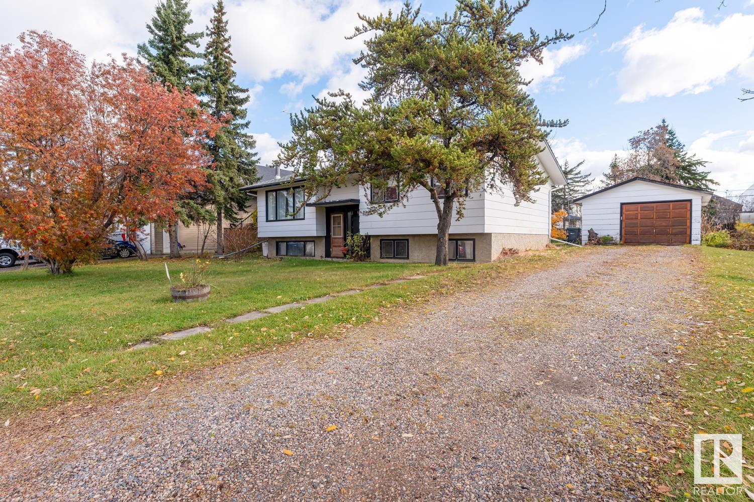Absolutely RARE find - this home has never been on the market before and sits on a triple lot that is just over half an acre in size. Property is fully landscaped and features mature tree throughout, alley access and a detached single car garage. The house is over 1400 sq ft and has been meticulously maintained by the original owner. Large kitchen and dining area, along with a spacious living room at the front of the house.  Down the hall is the main bath, and 2 bedrooms including the primary with half bathroom.  The 2nd bedroom used to be two rooms and could easily be converted back in to 2 rooms to make this a 3 bedroom up home. Downstairs there is family room with drybar, tons of storage and two more bedrooms that run from one into the other.  If you are looking for a home on a massive lot then you won't find anywhere else.