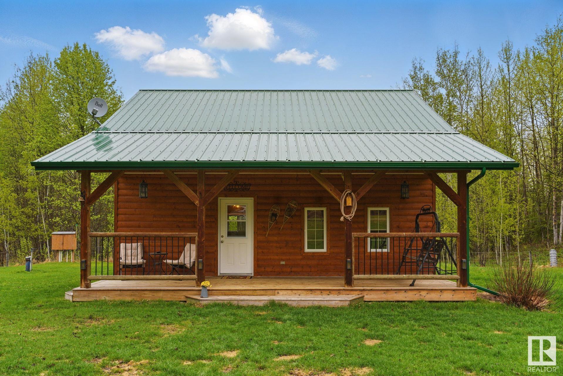 Looking for peace, privacy, and the perfect country escape? This gorgeous 4.99-acre retreat at the end of a quiet dead-end road checks all the boxes! Whether you're dreaming of a cozy year-round home or a four-season getaway, this one-of-a-kind property delivers. With over 1100 sq ft of immaculate living space, this 1 bed, 2 bath home with upstairs den is insulated, heated, and ready for all seasons. The charming split-log exterior, south-facing covered veranda, and sunny back deck with nothing to look at besides nature, offers the ideal spot to relax and soak in the beautifully landscaped yard. Need storage? You have three sheds, a tarp shelter, and a wood shed?plenty of space for all the toys. With 200A service and enough room for all your friend's and family's RVs, they'll be no need to look for a reunion spot! There's a drilled well and an upgraded septic tank and field. Just over an hour from Edmonton or Red Deer and 20 minutes from Pigeon Lake Village and Twin Lakes, this beauty won't last!