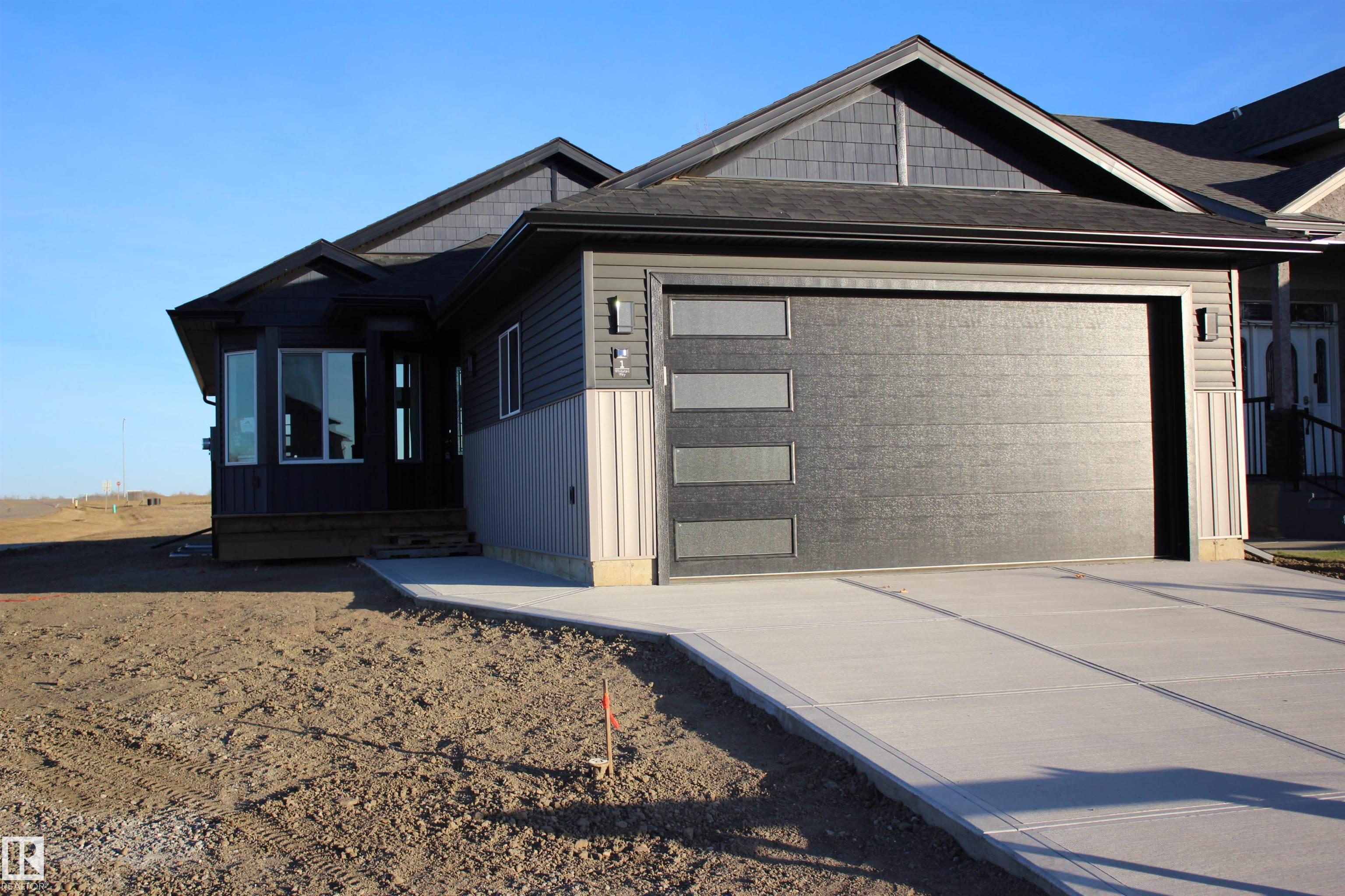 Brand new home! This bungalow home features 2 bedrooms plus a den, main floor laundry, open concept kitchen and livingroom and vaulted ceilings to enjoy the morning sunshine! The basement is designed for an additional 2 bedrooms, bathroom and family room. With an attached double garage, this home sits on a corner lot in the growing community of Whitetail Crossing in Mundare. Enjoy small town living in this wonderful community only a short 40 minutes east of Edmonton. With all the amenities like grocery store, daycare, bakery, banks, restaurants, curling and hockey rinks, 18 hole golf course-all within walking distance from your new home.   Town of Mundare offers a 3 year tax incentive on New Construction!