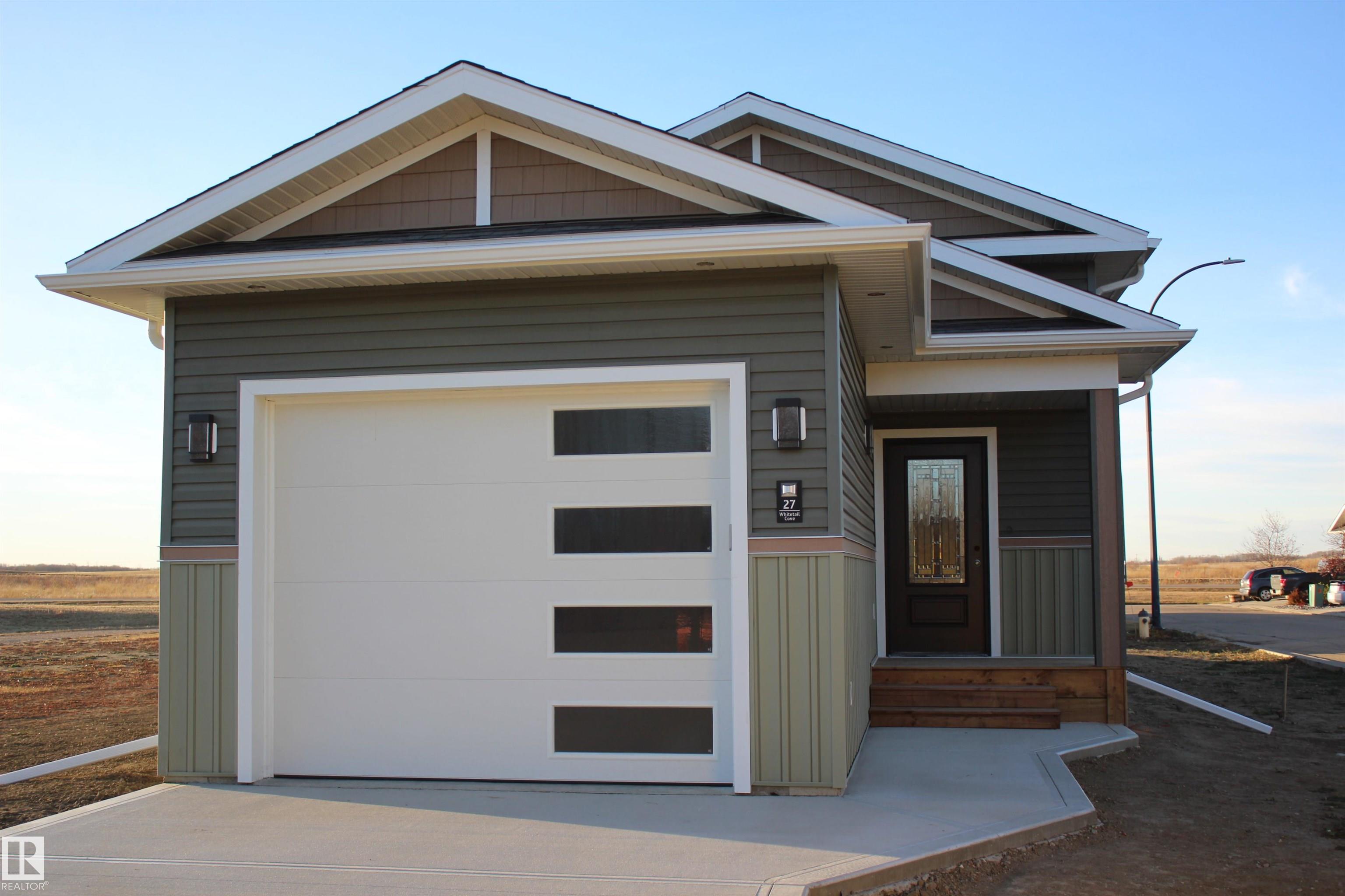 Brand new bilevel home with attached single garage! This house enjoys a great layout with 1 bedroom and full bathroom, livingroom, dining room and kitchen.  With a covered deck, you can enjoy the outdoors even in the rain. With a full basement ready for your finishing touches, it is designed for an additional 2 bedrooms, bathroom and family room. Enjoy small town life only a short 40 minute drive from Edmonton. This home is steps from the golfcourse tucked away in a cute cove. Mundare offers all the major amenities like grocery store, bakery, banks, restaurants, hockey and curling rinks just to name a few.  Mundare offers a 3 year tax incentive for new construction!