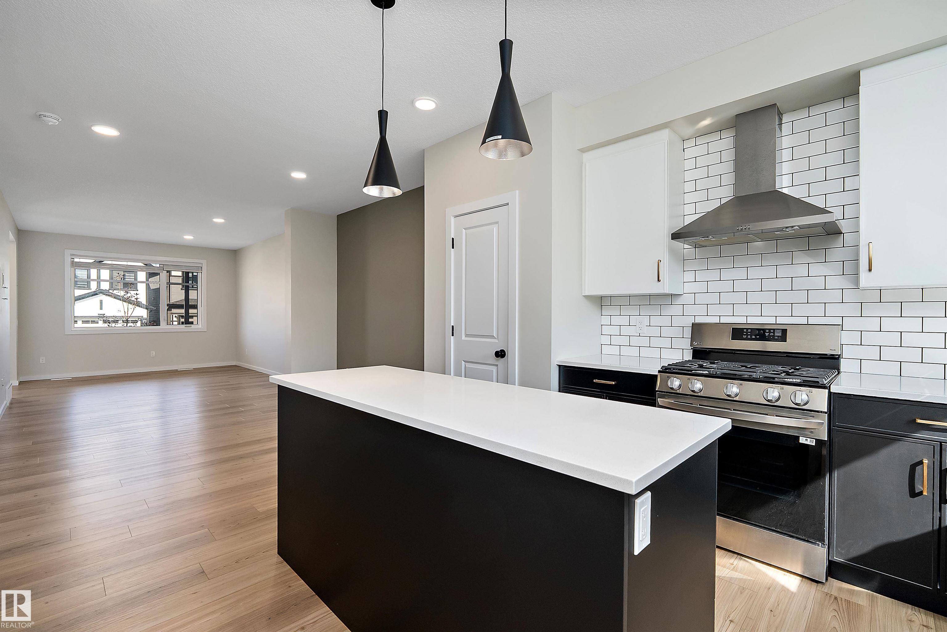 BETTER THAN NEW, this 1534 sq. ft. QUALITY BUILT "HOMES BY AVI, 2 STOREY, is ready for IMMEDIATE POSSESSION. GREAT ROOM floor plan featuring VINYL PLANK flooring, contemporary WHITE CABINETRY with upgraded STAINLESS APPLIANCES, including a GAS STOVE (220 is in for electric) and WATER/ICE feature on the REFRIDGERATOR plus QUARTZ COUNTERS and modern BRASS ACCENTS. A 2 piece bath & handy mud room off the back door leads to the SUNNY SOUTH YARD and DOUBLE DETACHED GARAGE that is insulated & drywalled! Up to a SPACIOUS PRIMARY that has a WALK IN CLOSET & 3 PIECE BATH, 2 additional bedrooms, a 4 piece main bath & CONVENIENT 2ND. FLOOR LAUNDRY. The basement features a SEPARATE ENTRANCE from outside and is ready for future development. The yard features low maintenance landscape and a brand new fence on one side! ELAN is a lovely new area in West BEAUMONT featuring PARKS, PLAYGROUNDS, WALKING TRAILS and wonderful GATHERING SPACES for FAMILIES and FRIENDS! It is PERFECT!