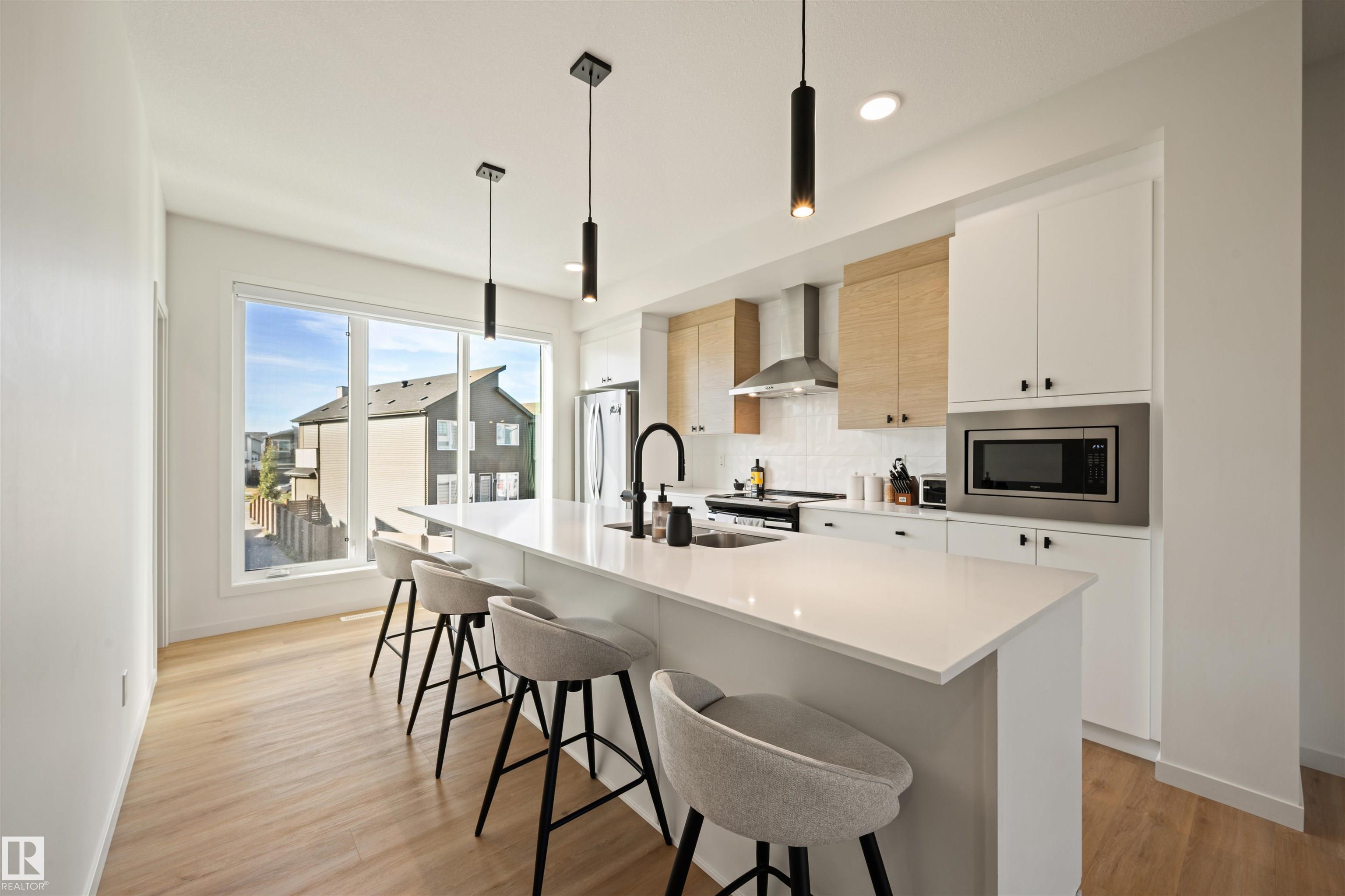 Welcome to the prestigious community of Charlesworth. This architecturally refined Cantiro home combines contemporary design with understated elegance. The main floor offers exceptional versatility with the option for dual offices or an office and lounge, complemented by a mudroom with custom built-ins and direct access to the double garage. Sunlight pours through expansive east- and west-facing windows, illuminating the open-concept living and dining areas. The rear kitchen is beautifully designed, featuring an expansive island adorned with quartz counters, an impressive walk-in pantry. Cantiro?s signature glass wall, alongside an open-riser staircase, anchors the main floor. Upstairs features two generous bedroom suites, each with a serene ensuite, and convenient upper laundry. Step outside and enjoy direct access to walking trails, greenery, nature and parks. Meticulously maintained, this residence offers a refined, low-maintenance lifestyle in one of southeast Edmonton?s most desirable communities.