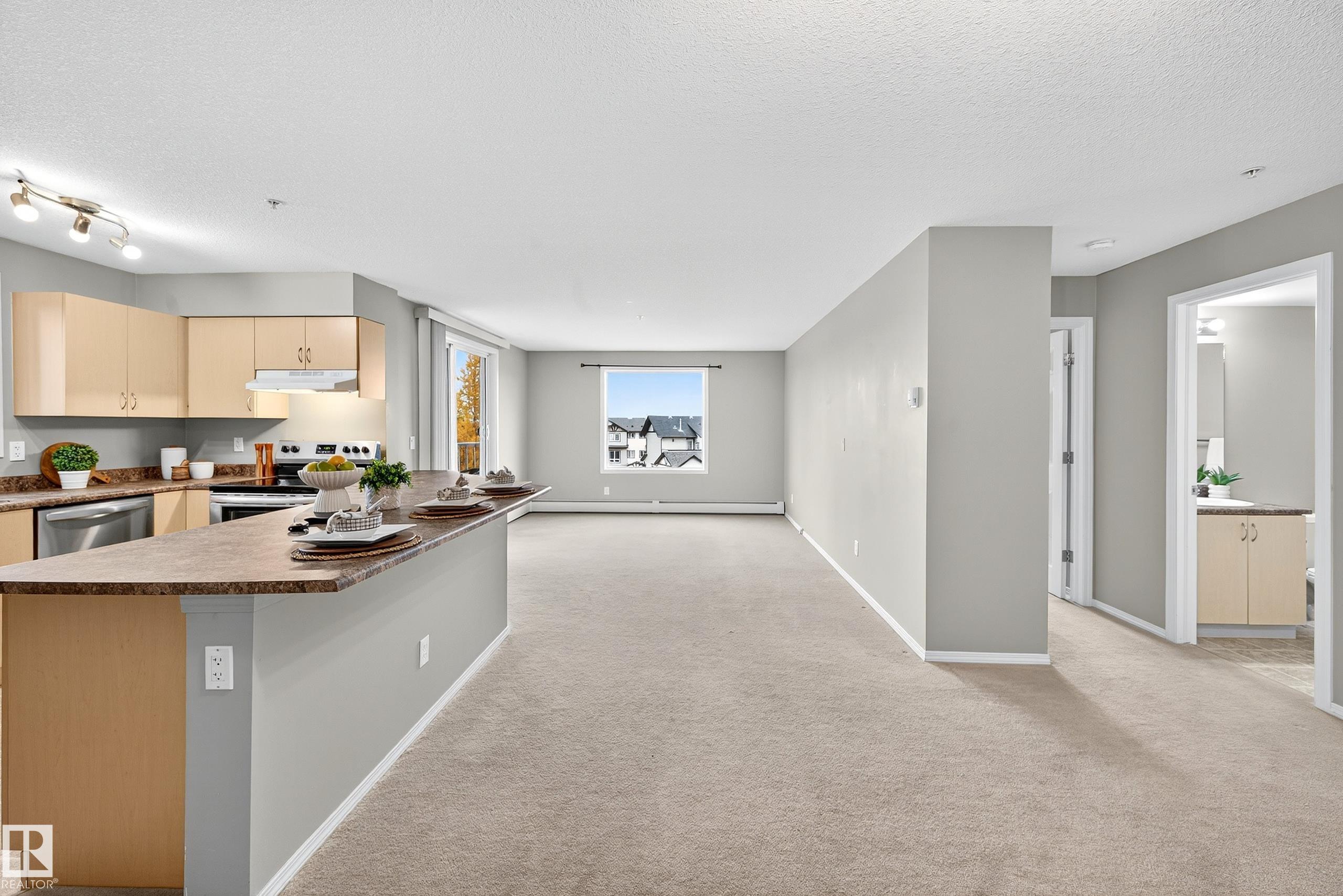 Welcome to Axxess PLUS @ Summerwood in the heart of Sherwood Park where this splendid 2-bedroom, 2-bathroom corner condo unit is ready to welcome its new owners. Fantastic location with all amenities just a hop away; shopping, hospital, schools, cafes, medical center, Emerald Hills Centre, Summerwood Park, PLUS so much more. You will LOVE the abundance of large windows that brings in array of natural light throughout. Great open concept layout with neutral tonnes aimed to please. Entertaining peninsula style eat-on countertop anchors spacious kitchen that overlooks living room with large west facing balcony (BBQ gas line). Primary suite has private walk-thru WIC to ensuite. Spacious foyer, in-suite laundry, lots of storage space, appliances, abundance of kitchen cabinetry, professionaly cleaned carpets, reasonable condo fees in well maintained complex makes this opportunity a GEM purchase. Fantastic for 1st time buyers or investors. Don?t let this one slip away?MUST SEE!