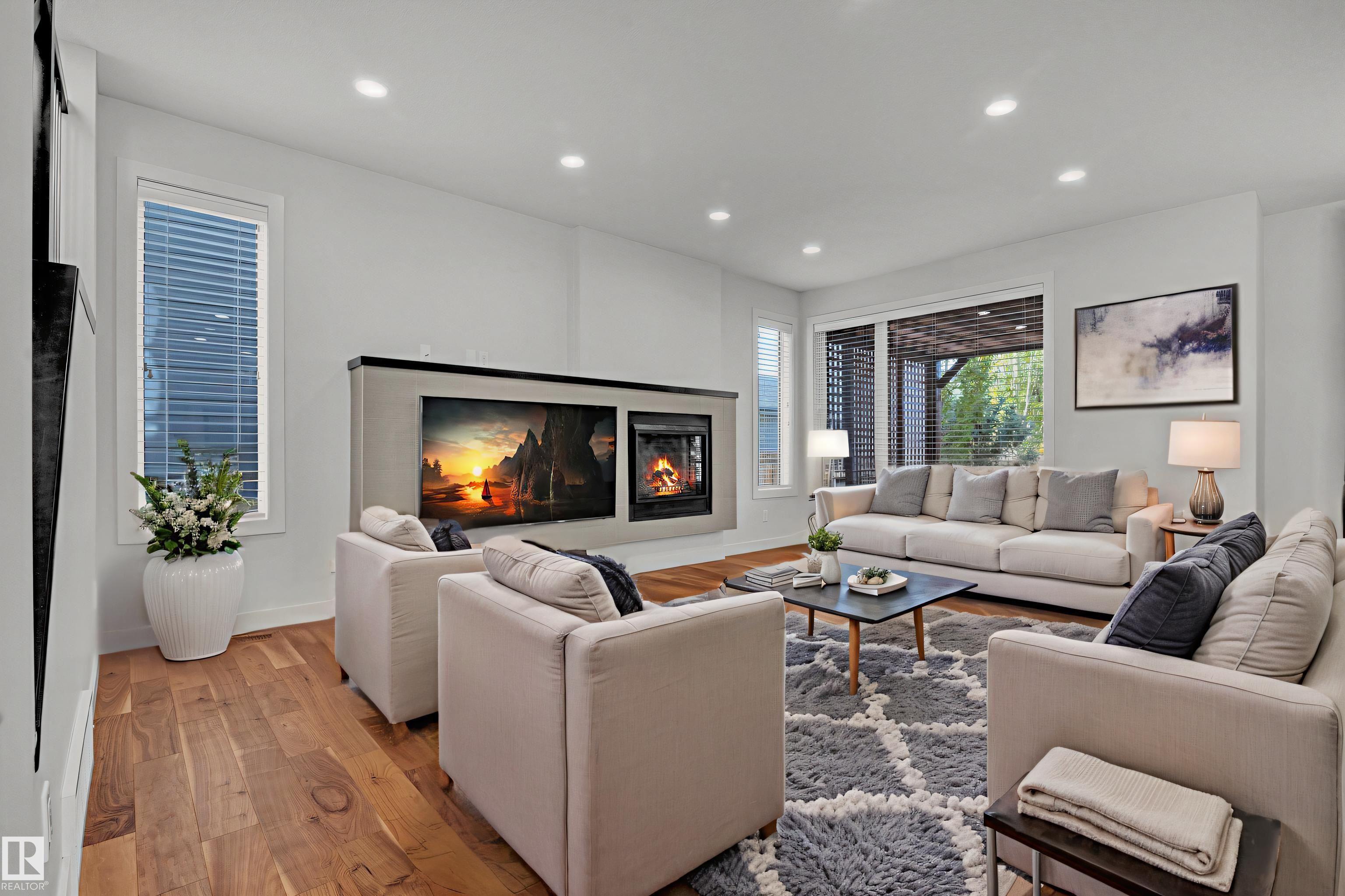 Discover refined living in this fully finished, luxury half duplex surrounded by the breathtaking beauty of Whitemud Creek Ravine and MacTaggart Sanctuary. This modern 2-storey blends upscale design with serene, natural surroundings. The rare triple-car garage and striking curb appeal set the tone for what?s inside: bright, open spaces with brand new engineered hardwood on the main floor, cork-backed vinyl plank in the basement, plus full LED Adjustable lighting and fresh paint throughout. The professionally landscaped backyard, complete with a two-tiered deck and custom pergola, creates a private retreat ideal for summer gatherings or quiet evenings outdoors. Other recent upgrades include newer appliances and a heated garage. Steps from scenic trails, boutique dining, grocery stores, and more essential amenities, this home offers refined comfort and effortless convenience in a truly exceptional ravine setting. Some photos were virtually staged.