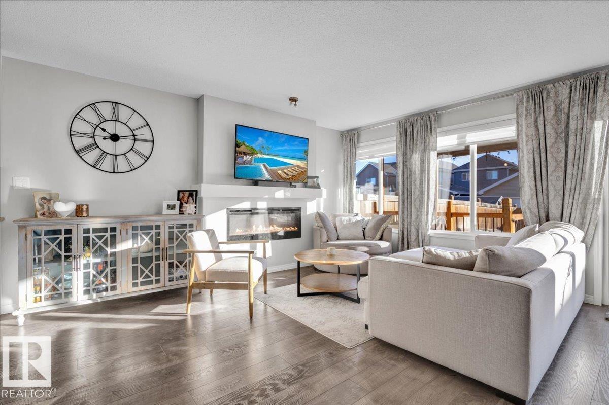 Welcome Home! Wonderful Family Ready Duplex in Summerside Edmonton. Live the good life with private exclusive access to Summerside Beach Club with year round enjoyment to the lake, beach, parks, and more. Terrific large floor plan with open concept, private fenced yard with deck onto rear alley, and single attached garage. Large sunken entrance way leads to main floor half bathroom and access to attached garage. Walk through upgraded kitchen with oversized island. Ample counter space and cabinets with corner pantry. All appliances included. Overlooks main floor living room with electric fireplace and large area for dining room. Patio door leads to the perfect out door space. Top floor opens into large bonus room family area. Walk in laundry room. Large bedrooms and 2 full bathrooms. Master bedroom has upgraded walk in closet (wow) and full ensuite bathroom with double sinks. Unfinished basement provides potential and tons of storage. Pride of ownership! Perfect home or investment property. Awesome!