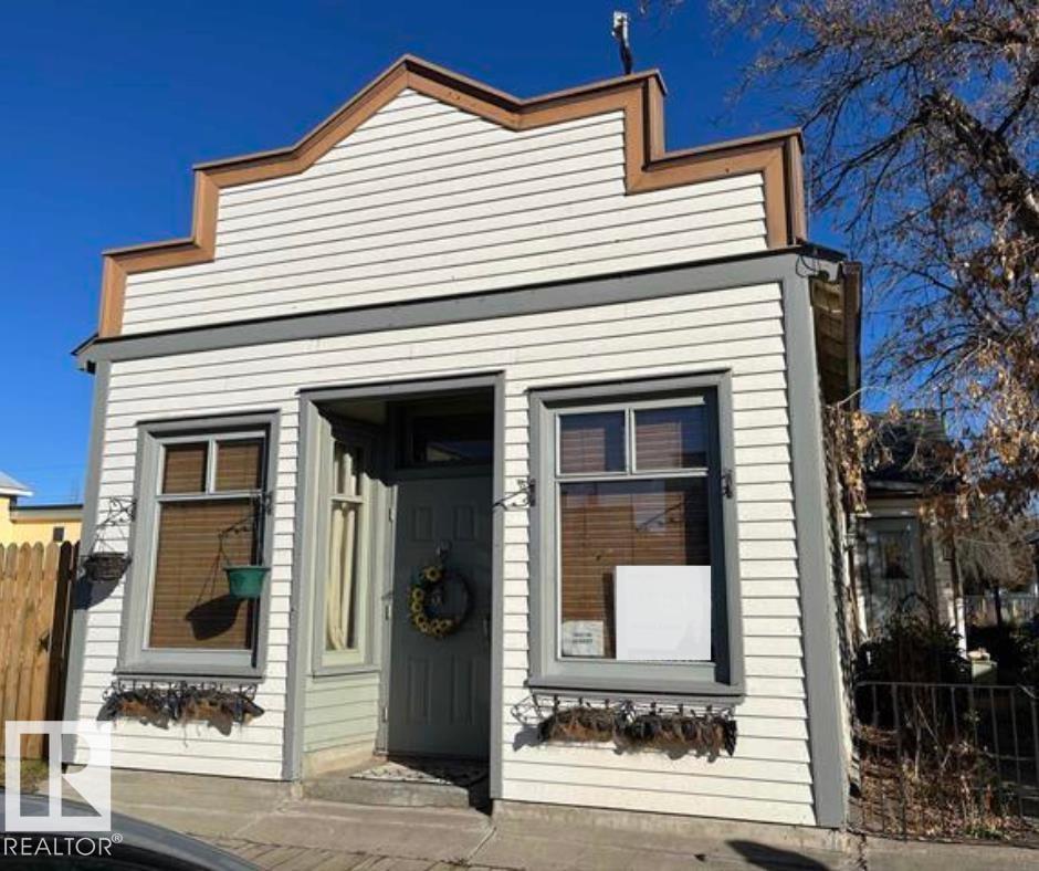 This one of a kind 1925 character home, featuring 2 bedrooms, up dated kitchen, large pantry and a 4pc bathroom with a claw foot tub.  At the front of the home you'll enter into a large living room, which may be used as a home based business if needed. A modern kitchen with stainless steel appliances (2022)  you'll also enjoy a main floor laundry room and large master bedroom that has access to the back yard. The yard is fully landscaped and fenced and also incudes an oversized 14' X 36' single car garage. Perfect location on quaint main street with walking distance to everything, definitely tons of possibilities for business or just to enjoy a quiet life. Only an hour and a half from Edmonton. Upgrades are shingles on home and garage, furnace, hot water, new electrical and plumbing (2022)