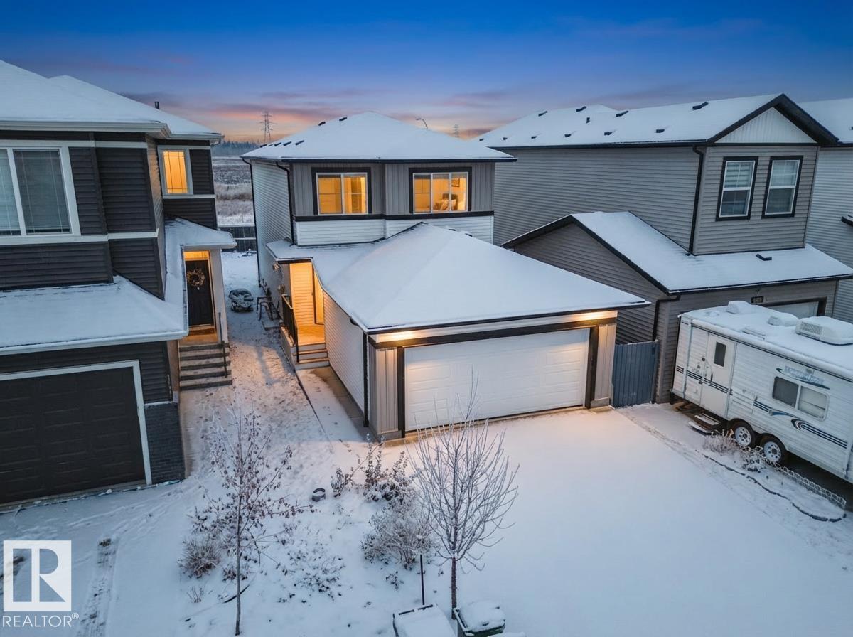 INVESTOR ALERT! Opportunity knocks with this 2023-built 2-storey featuring a custom 1 bed legal suite in the established community of Kirkness. Just a stone throw from Manning Town Centre, Movati, Costco, schools, transit, and the Henday. This location is unbeatable for families or future tenants! The home is bright, welcoming, and move-in ready, starting with a generous foyer and flowing into open-concept living, dining, and a stylish kitchen with smart stainless steel appliances (yes, even an air-frying oven!). A 2-pc powder room and double garage sit conveniently off the entrance. Upstairs offers 3 bedrooms, upper laundry, and a dreamy primary retreat with walk-in closet and 5-pc ensuite. The backyard is spacious and ready for your touch. Downstairs, find yourself in the cozy legal suite. Perfect as a mortgage helper or multi-generational space. Enjoy the high-efficiency boiler system with separate smart thermostats for year-round comfort. Don't miss out on your chance to live while making a living!