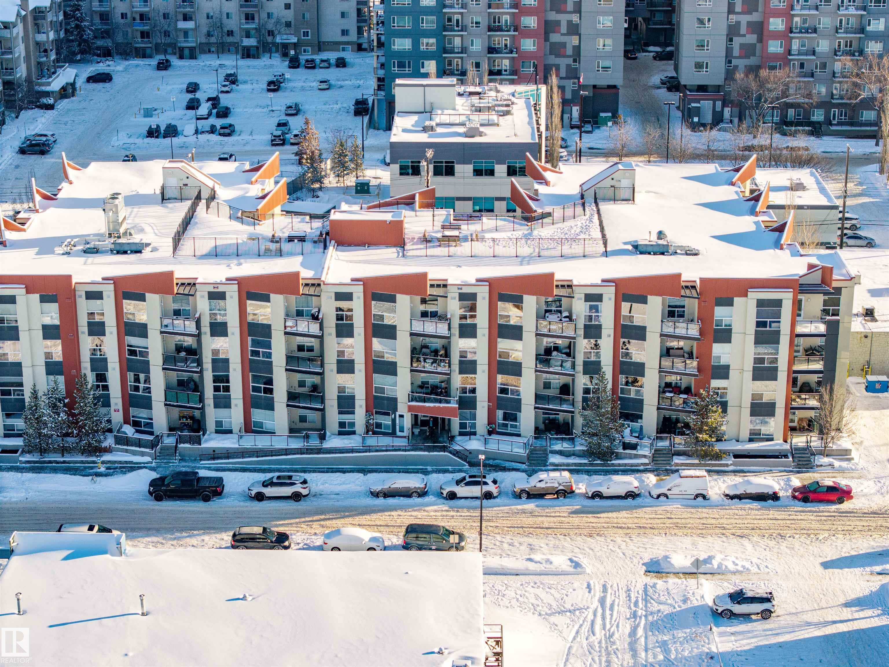 *Discover The Best Priced Condo at High Street District Properties**: a fresh and modern development nestled in the heart of Downtown Edmonton. Ideally situated just one block away from the esteemed 124 Street, ICE DISTRICT & THE FAMOUS BERWEY DISTRICT ON 104 Ave . STEP INSIDE THIS LARGER CORNER END UNIT and you are greeted by an upgraded kitchen with granite counter-tops and a larger living room with stunning hardwood flooring along with a 2 pice guest bathroom,  along with a generous dining area and/or unique flex space off the living room. The Huge Wrap Around Patio is ideal for entertaining guests or enjoying a quiet evening outdoors. he master bedroom boasts additional windows for natural light, a walkthrough ensuite bath, and an impressively large walk-in closet. A Huge Bonus is the Underground Titled Heated Parking Stall.  Stall along with a GREAT ROOF-TOP PATIO.  THIS UNIT IS BY FAR THE BEST PRICED IN THE COMPLEX. "VIEW TODAY"!