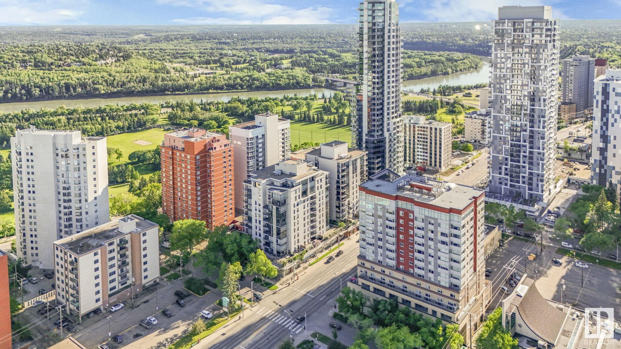 Experience luxury living in this spacious 1522 sqft 2 BED + DEN, 2 BATH condo located in one of Edmonton’s premier condo complexes. This home offers unparalleled convenience with 2 SIDE-BY-SIDE titled UNDERGROUND PARKING STALLS. Revel in the elegance of modern HARDWOOD FLOORING, GRANITE countertops, and 9ft CEILINGS that showcase stunning river valley views through floor-to-ceiling windows. The kitchen is a CHEF'S DREAM, featuring a large island, ample cabinetry, and stainless steel appliances. Enjoy the bright, open layout with a spacious living room warmed by a 3-SIDED GAS FIREPLACE. Step out onto your PRIVATE BALCONY from the dining area to take in breathtaking cityscapes. The master suite is a retreat, complete with a walk-in closet, a 4-piece ensuite with a soaker tub and separate shower. Additional amenities include in-suite laundry, extra storage, and access to a CAR WASH, RENTAL SUITE and UNDERGROUND VISITOR PARKING. Convenience is at your doorstep with nearby dining, cafes, golfing and trails!