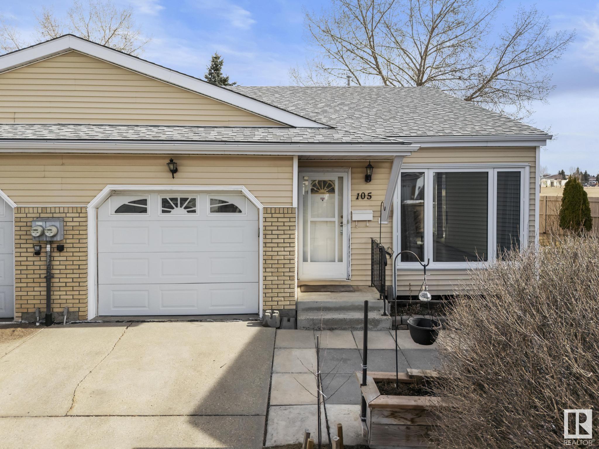 Welcome to carefree adult living in Callingwood Village—an exceptional 55+ community! This beautifully maintained bungalow-style half-duplex backs onto greenspace—no busy roads, just privacy, and peace from your 3-season heated sunroom. With 1,160 sq. ft. of bright, open-concept living, you'll love the vaulted ceilings, functional kitchen, sunny living and dining areas, and central A/C for year-round comfort. The main floor features 2 very spacious bedrooms, a 3-piece renovated bathroom with spa shower, main floor laundry, and an attached single garage with an accessible ramp). Downstairs offers a cozy den, a renovated full bathroom, a workshop space, and plenty of storage. Tucked into a quiet cul-de-sac, just steps from Callingwood Shopping Centre, this well-managed complex handles snow removal, and lawn care, and offers extra visitor parking. Enjoy the freedom of low-maintenance living in a welcoming, peaceful setting—this is the 55+ lifestyle you’ve been waiting for!