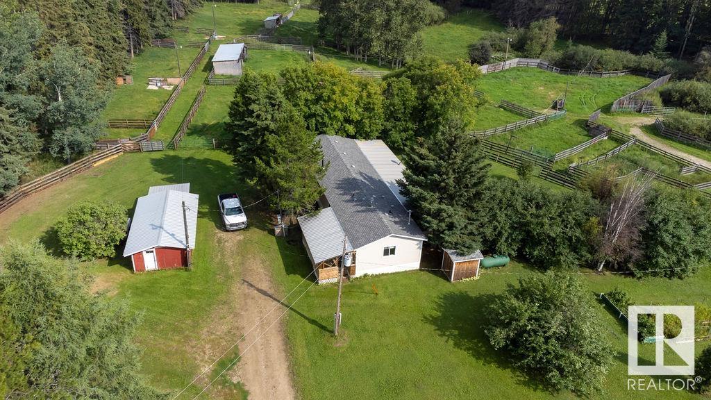 This amazing 60 acre parcel has been groomed & maintained since 2004. There are trails you can drive your vehicle or quad through & surround yourself with majestic trees & nature. There are shelters, a barn & other structures & sheds. The owner has raised cattle & equipped the property into separate pastures, all with their own Watering troughs & power poles for night vision. The modular home was built in 2002 & offers 2 decks, 2 wells (one in a well house) 2 septics & shingles replaced in 2023. The open concept offers a generous Oak kitch with a central island, a spacious LR with corner wood Stove & 2 patio doors to the S Deck. There are 2 secondary bdrms & a large Primary Bdrm with a W/I closet & 3pc ensuite. On the Far East of the property is a small cabin with a deck & fishing pond . This property would be perfect for cattle farmer or anyone who wants to raise animals. Chip lake is across the hwy where you can boat or go fishing. Close is Wildwood, a Hamlet on RR 92 & further E on RR 74 is Entwistle