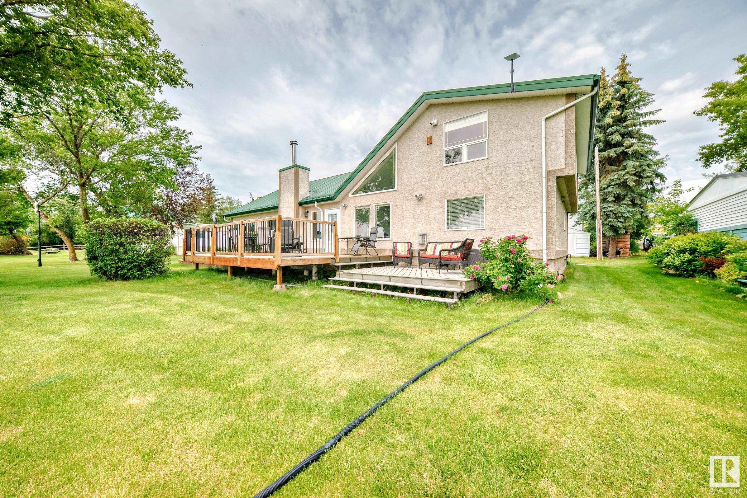 **Stunning Waterfront Retreat in Sandy Beach, Lac Ste-Anne County** Escape to your personal oasis at this magnificent waterfront property nestled in the serene community of Sandy Beach. Just 40 minutes from Edmonton, this picturesque retreat offers the perfect blend of tranquility and comfort. This charming home features vaulted ceilings,  3 spacious bedrooms + office, 2 inviting living rooms providing ample space for relaxation and entertainment. Large windows flood the interiors with natural light and offer breathtaking views of the lake. The main floor offers a bright and vaulted kitchen with quartz countertops, dining area overlooking the lake, large laundry room with full bath, 2 living rooms with F/P, office space and primary bed with ensuite and walk-in closets. The open to below second floor offers 2 large guest bedrooms. The best feature of this home is the expansive  deck, where you can soak up sunrises or unwind. Huge shop and a secure dbl detached garage ensure plenty of space for equipment.