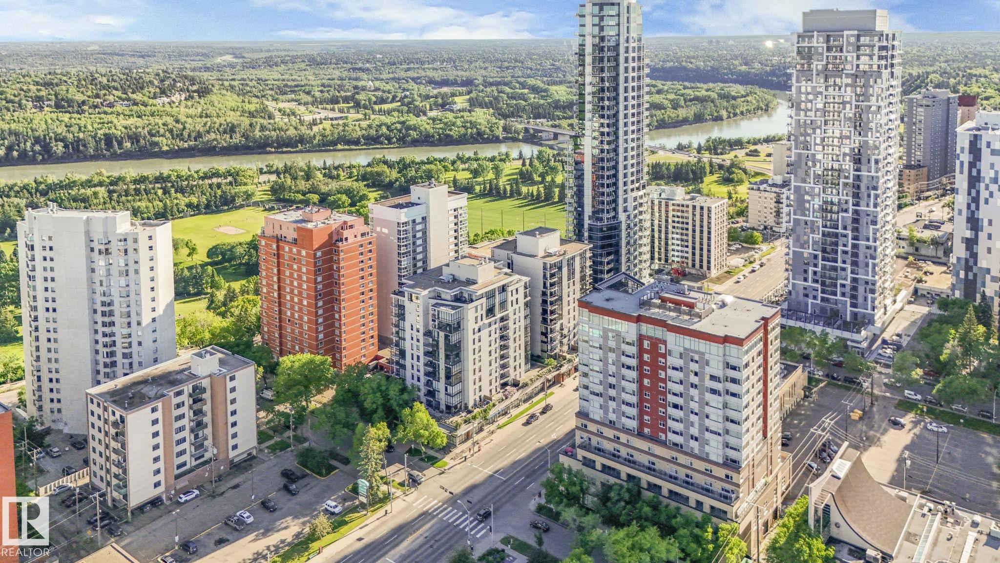 Experience luxury living in this spacious 1522 sqft 2 BED + DEN, 2 BATH condo located in one of Edmonton’s premier condo complexes. This home offers unparalleled convenience with 2 SIDE-BY-SIDE titled UNDERGROUND PARKING STALLS. Revel in the elegance of modern HARDWOOD FLOORING, GRANITE countertops, and 9ft CEILINGS that showcase stunning river valley views through floor-to-ceiling windows. The kitchen is a CHEF'S DREAM, featuring a large island, ample cabinetry, and stainless steel appliances. Enjoy the bright, open layout with a spacious living room warmed by a 3-SIDED GAS FIREPLACE. Step out onto your PRIVATE BALCONY from the dining area to take in breathtaking cityscapes. The master suite is a retreat, complete with a walk-in closet, a 4-piece ensuite with a soaker tub and separate shower. Additional amenities include in-suite laundry, extra storage, and access to a CAR WASH, RENTAL SUITE and UNDERGROUND VISITOR PARKING. Convenience is at your doorstep with nearby dining, cafes, golfing and trails!