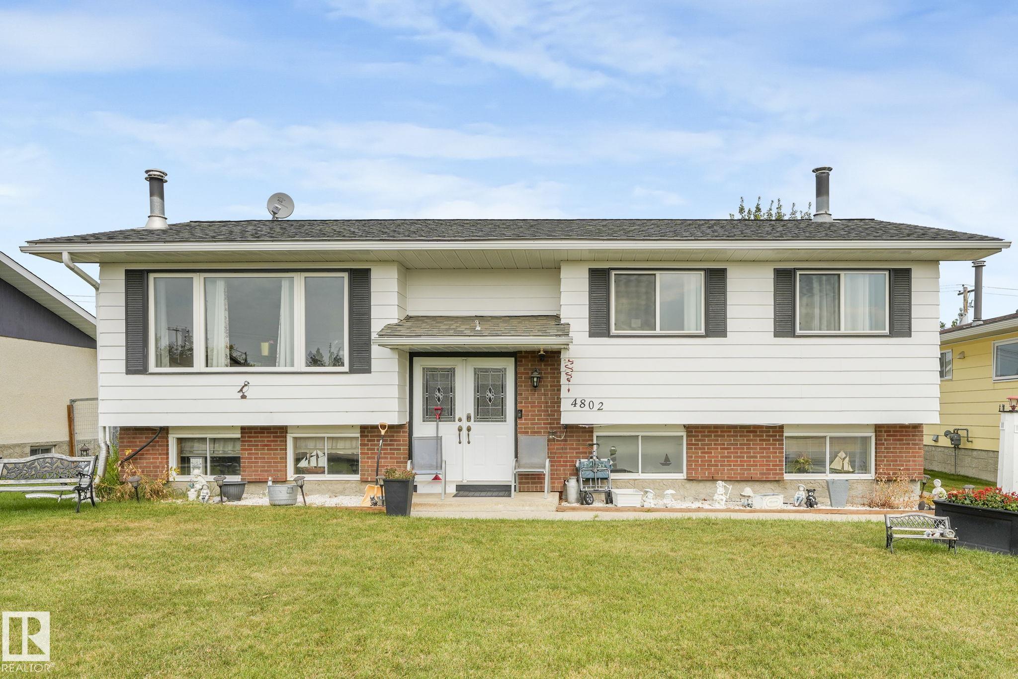 Exceptional family home in Mayerthorpe! This 3+2 bed, 2.5 bath home boasts an exceptional floorplan top to bottom. From the bright living room w/fireplace, clean kitchen w/island, ample cabinetry & counter space, and the family dinning area. There's also the primary bedroom w/large closet and 2-piece ensuite, and 2 addition main floor bedrooms offering even more living space for your family. The 4-piece bathroom, storage closet, and back entrance closet complete the main floor. The lower level shines with a huge rec. room w/fireplace and hot tub, 2-piece bath, 2 additional bedrooms, storage closet, and convenient utility/laundry room. The private landscaped backyard includes a low maintenance deck w/NG BBQ hook-up plus storage underneath, shed, and a beautiful apple tree. There's also a huge double detached garage giving you plenty of parking, plus RV parking. Located on a paved street and steps to school, park, shopping, and hospital. This home is a rare find! Move-in ready with charm & modern updates.