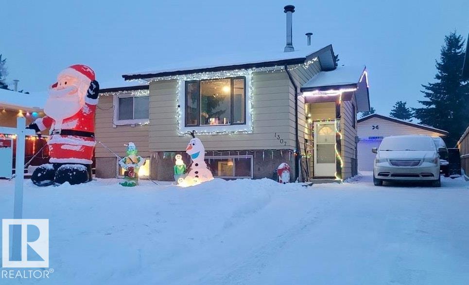 Discover this immaculate bi-level in the family-friendly area of Crawford Plains. Lovingly maintained fireplace, fresh paint, new flooring, & upgrades to fence & deck. The main floor welcomes you with abundant natural light in the cozy front living room with a beautiful wood burning fireplace & functional kitchen. Down the hall there?s a full 4 pc bathroom, a master bedroom with 2-piece ensuite & a second bedroom. The lower level has a third bedroom, freshly re-done 3-piece bathroom, a den/office with built-in shelving, family room for relaxation & entertaining & a spacious utility/laundry room. Step outside to a large deck overlooking a fully fenced backyard, your private outdoor space. Playground included. Front yard has a raised garden bed along the front of the house & 2 small planter boxes for those starting their urban gardening. Oversized 24' x 26' double garage with 220 power, insulated & heated for storage & hobbies. This property is move-in ready, meticulously cared for, definitely worth a look.