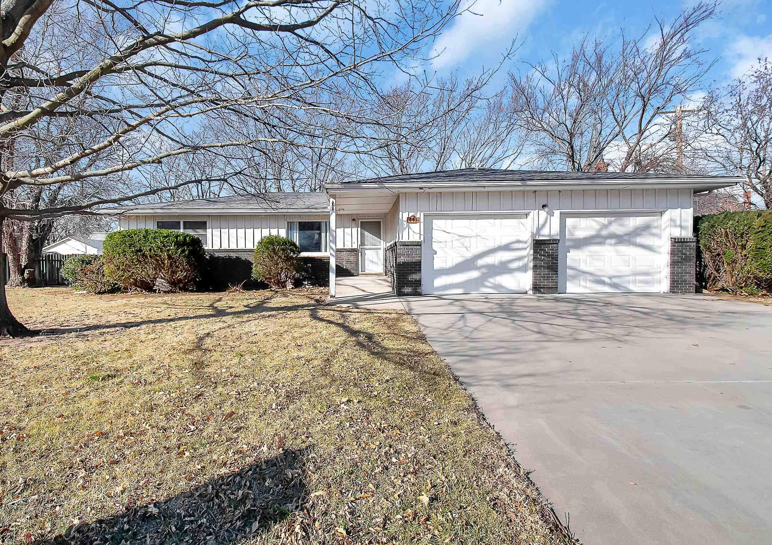 Spacious and move-in ready 4 BR, 1.75 bath home on a large fenced corner lot in Andale! New carpet a