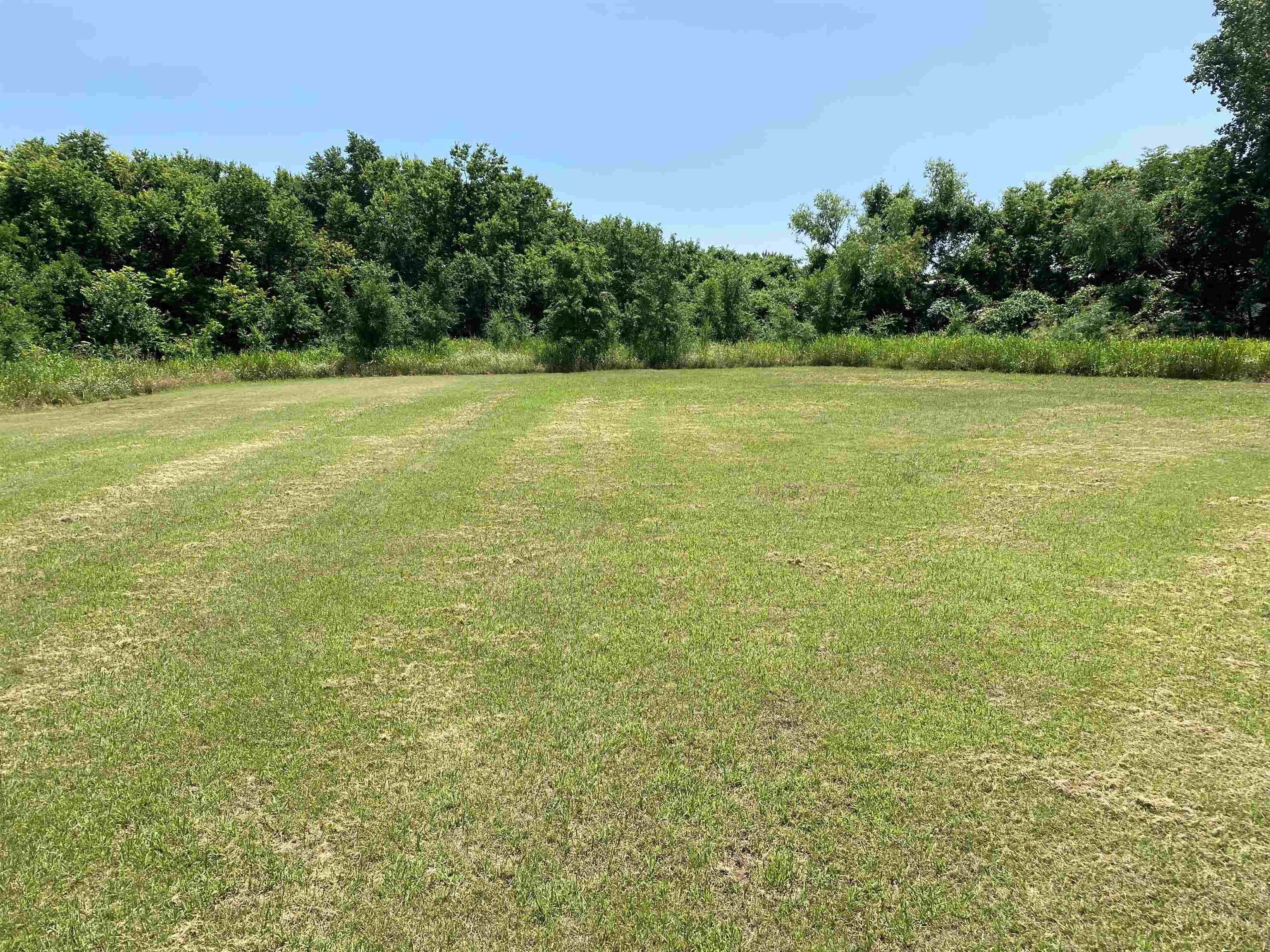 Dream big with this 2.5 acre lot located along the central business corridor of Arkansas City. This large lot has entry access to North Summit Street and expands to a level clearing ready for your pad work. Utilities are on site.  This property can be combined with the adjoining property (3122 N. Summit), which includes a free-standing commercial building, for package pricing. Call for more information.
