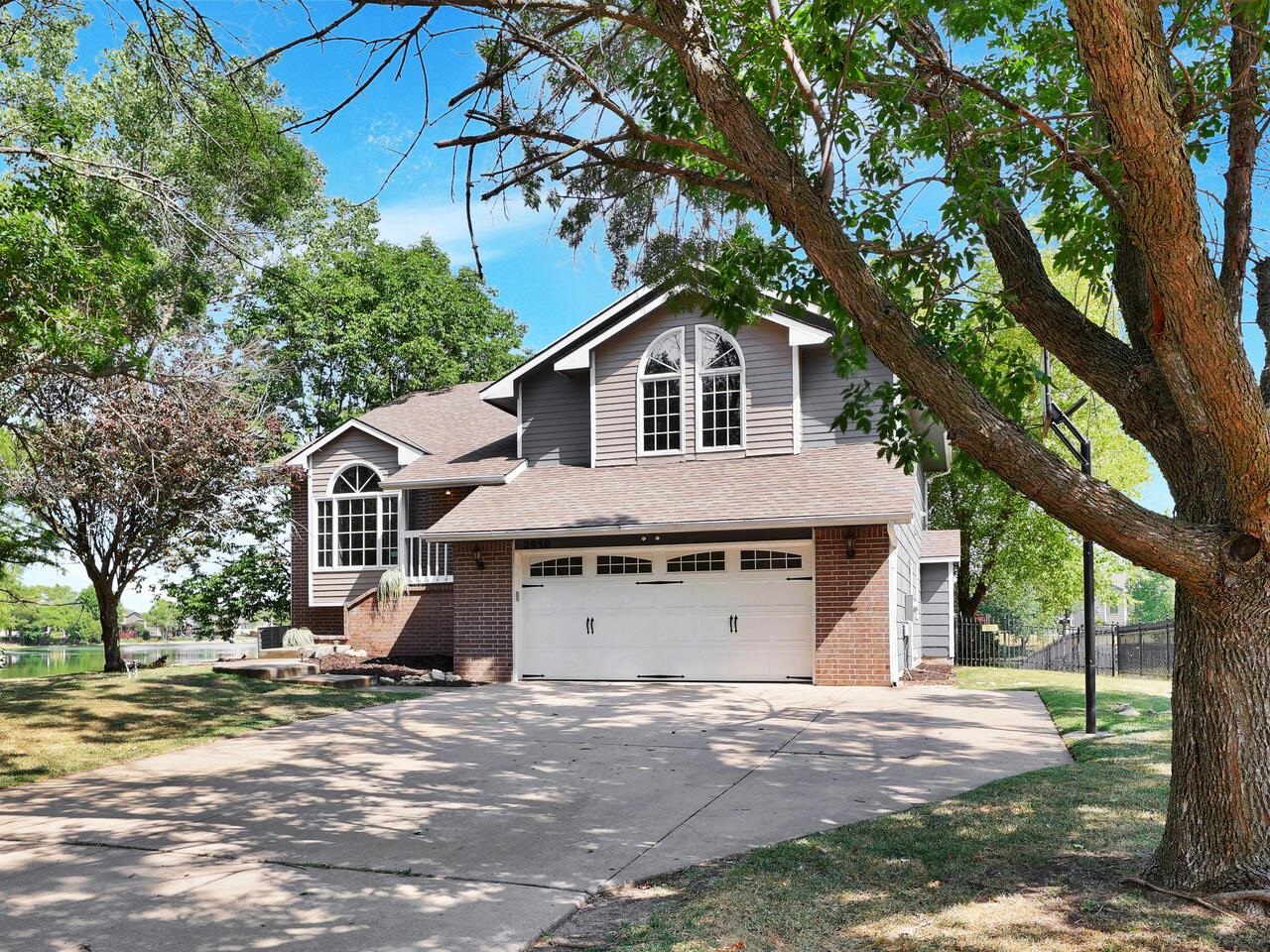WELCOME HOME! This residence is located in south Derby nestled among many mature trees on a .70 acre