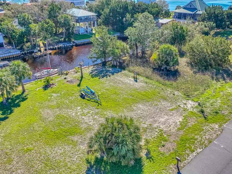 Check out the Aerial Tour https://youtu.be/1lo4YpUj8s8  Shell Pt Beach Canal Lot - An awesome canal lot for a future home. This centrally located lot has quick access to great fishing in the gulf by boat within 5 minutes. There is a 200amp underground service for a future home, with electric and water to the dock and all 4 corners of the property. There is an RV hookup at main electric station. This lot is graded, ready to build, with established setbacks, survey, elevation certificate and soil borings. This comes with building plans for a 3BR/2BA home with wrap around walkway from front to back porches.  There are several citrus fruit trees on the property.  The lot is situated among fine beach homes and less than one block from the beach on a paved cul-de-sac street.  Shell Pt is a golf cart community with fun friendly neighbors who enjoy many festivals and community functions.  You just can't beat the sunrises and sunsets on this point of land.