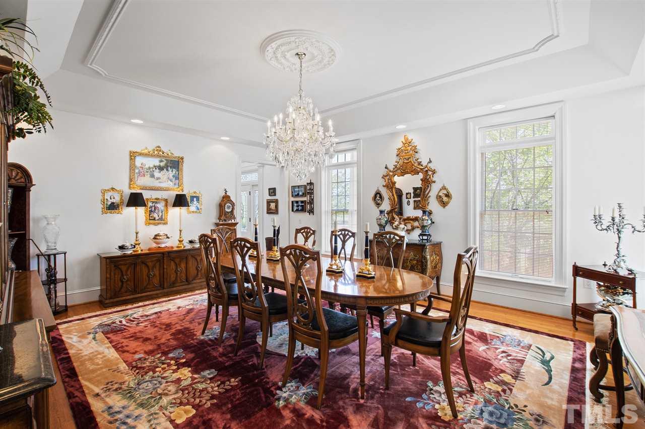Traditionally located off the front foyer is the large formal dining room with exquisite crystal chandelier.
