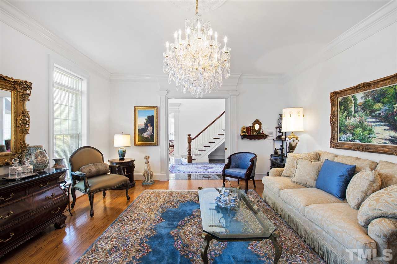 Also, traditionally located off the grand foyer is the formal living room with equally as exquisite crystal chandelier.
