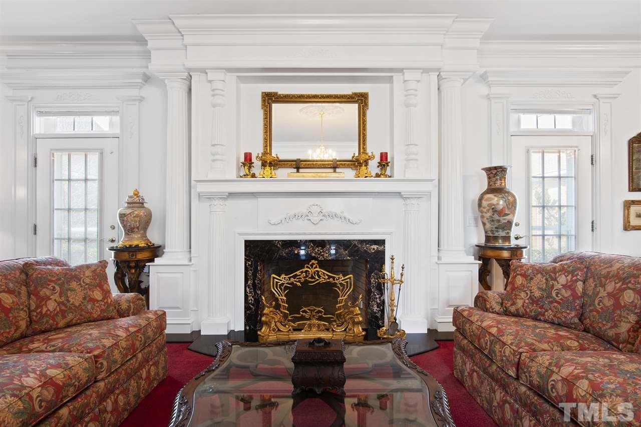Note the intricate custom moldings and millwork around the fireplace and doors.