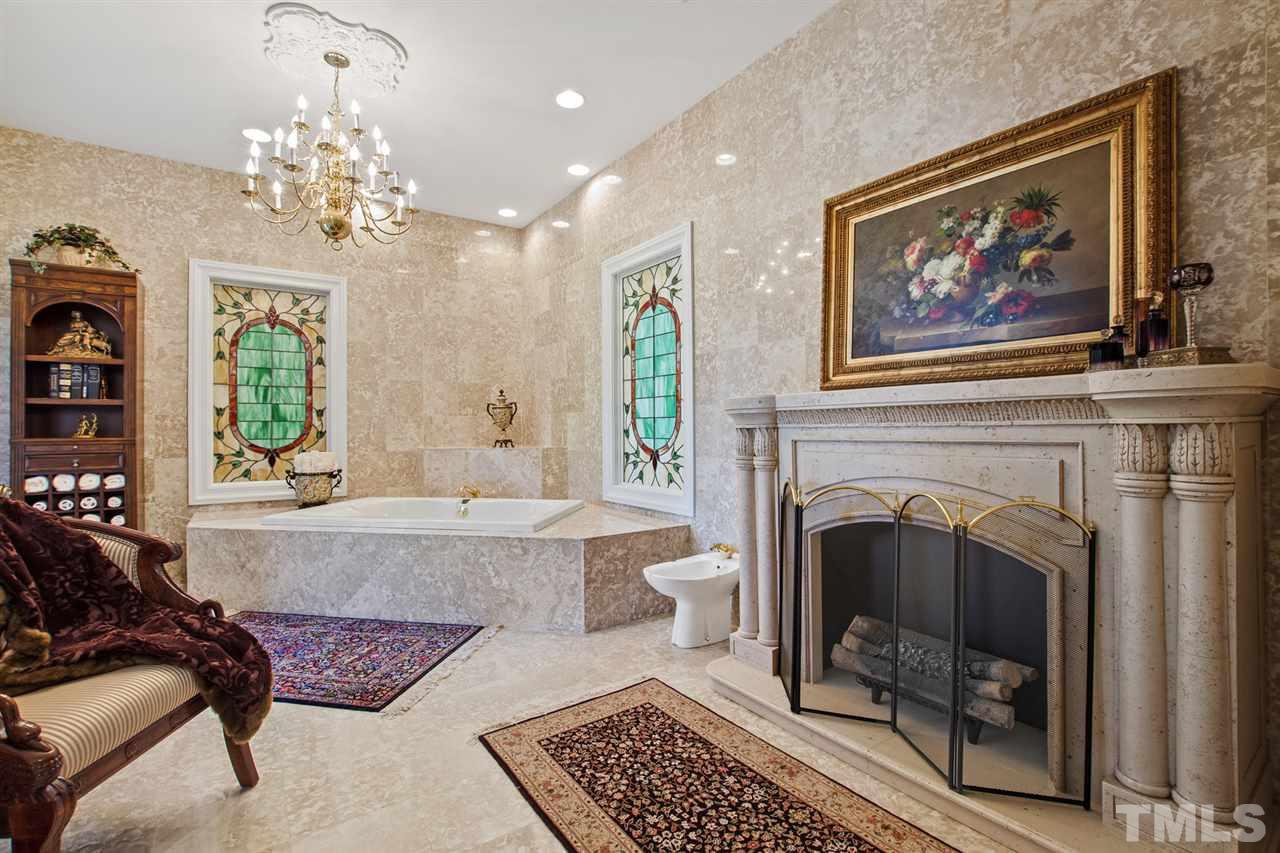 Master suite includes salle de bain with electric fireplace, bidet, and large garden tub.