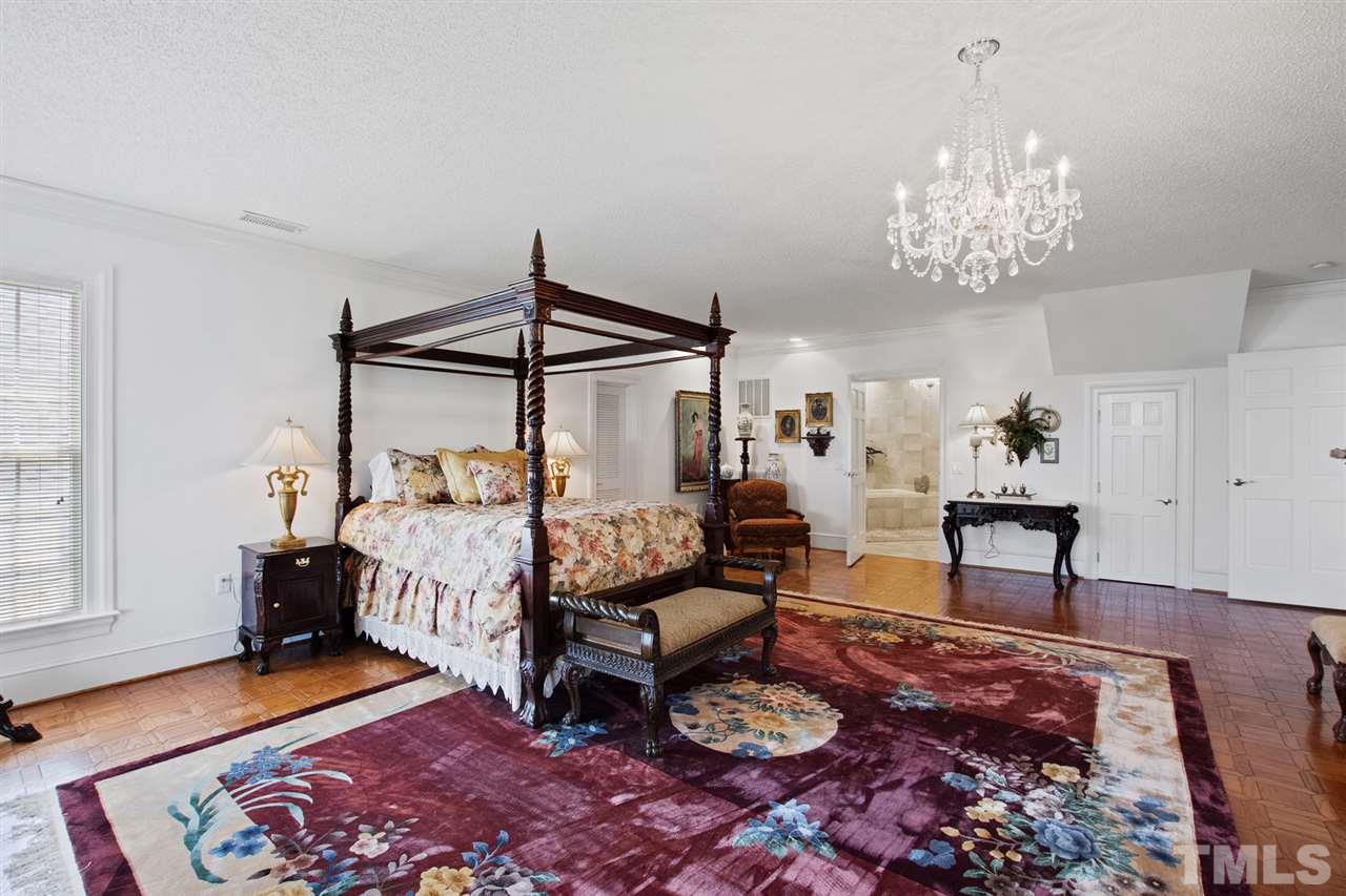 Very generous guest suite with private marble bath on second floor boasts custom hardwood floors, large crystal chandelier, and two closets.