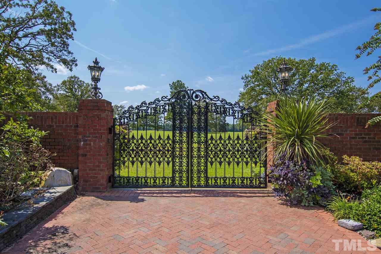 Artfully-crafted wrought iron gates lead you from the main courtyard of the owner's residence to vast picturesque acreage.