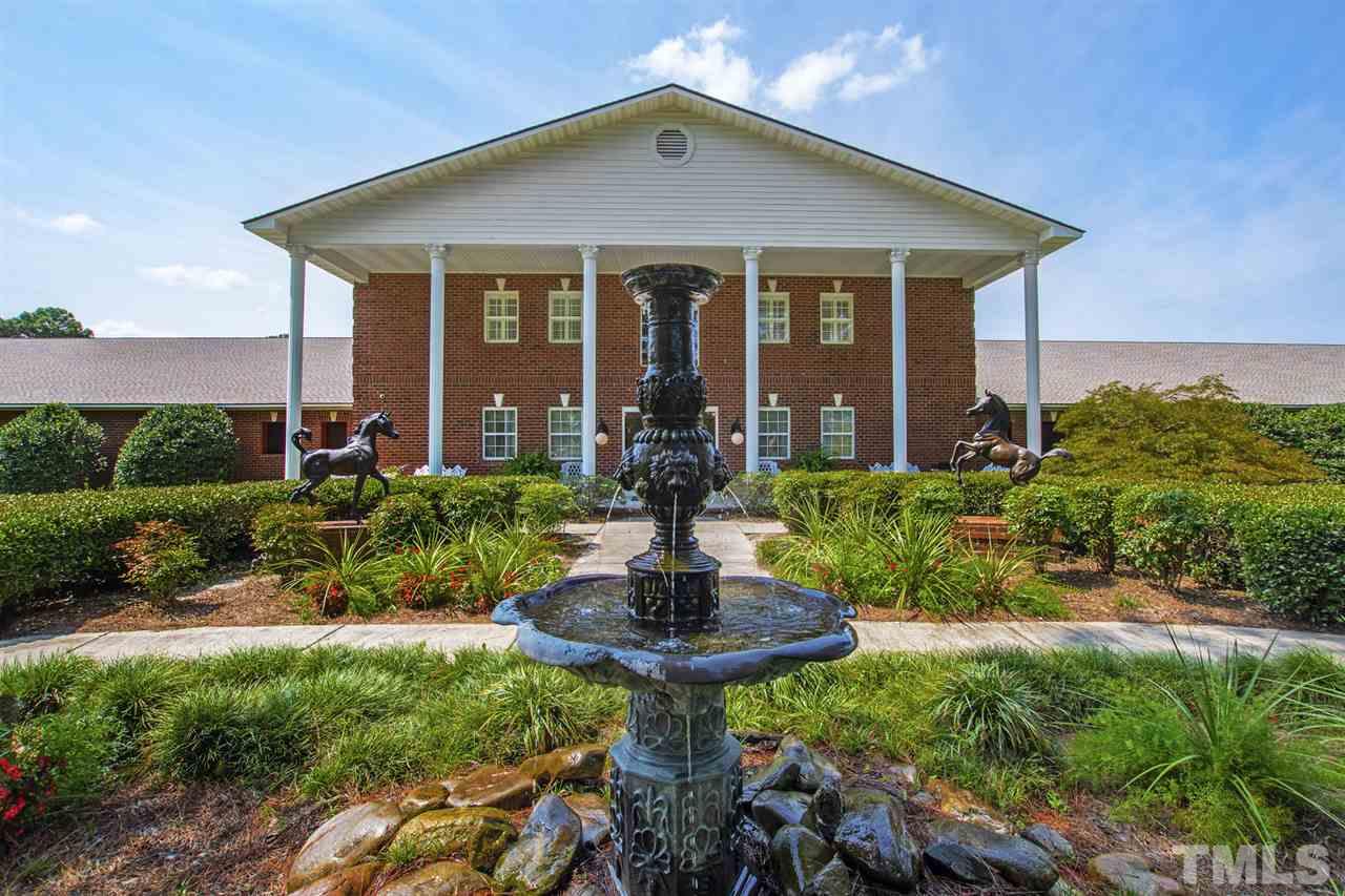 Located at 440 Devin Drive is a state-of-the-art, brick and block main barn, which houses reception areas, offices, living quarters and social room above 64 stalls. The fountain and horse statues are bronze.