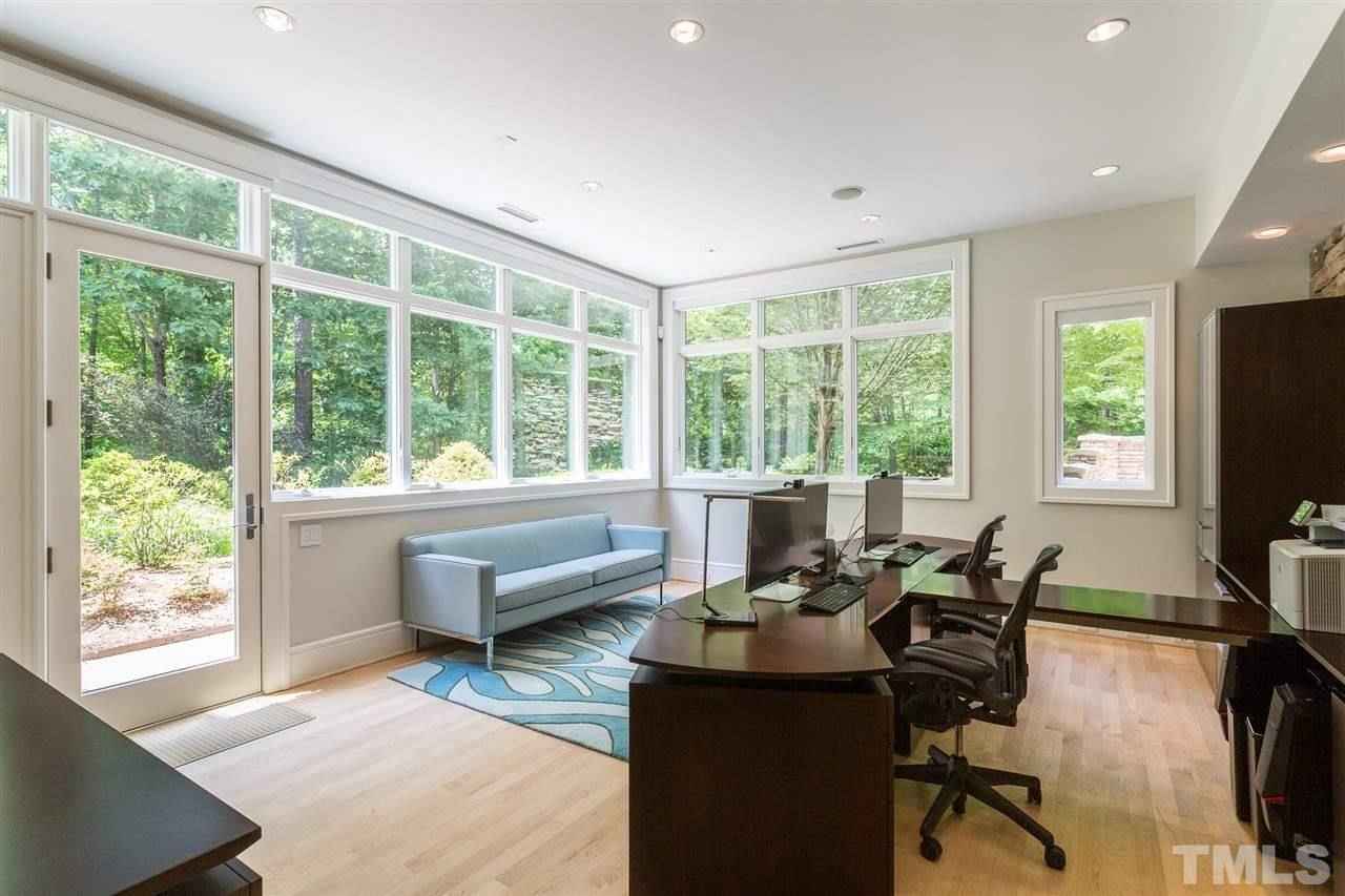 The home office has been designed to promote both enjoyment & productivity in a work setting. Features include 2 stone walls, abundant windows,10-ft ceilings, and automated shades. Visitors can access the office without entering the rest of the home.