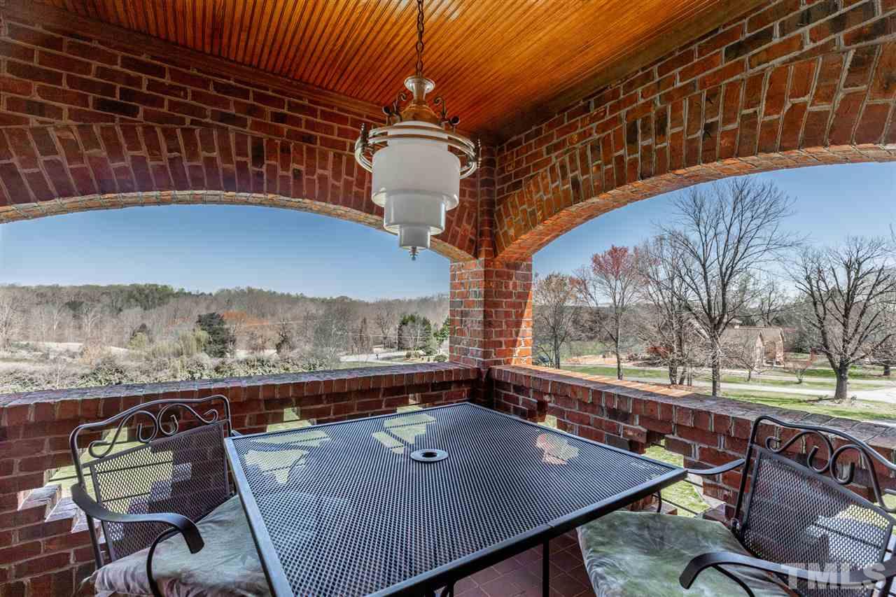 This covered porch with a spectacular view is off of the master bedroom sitting room