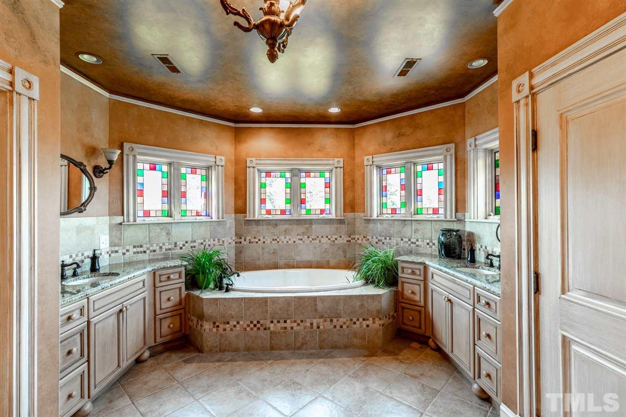 Large shower with multiple shower heads, drying off area with multiple heat lamps.  The vanity room connects the bigger of the 2 closets with the bathroom.