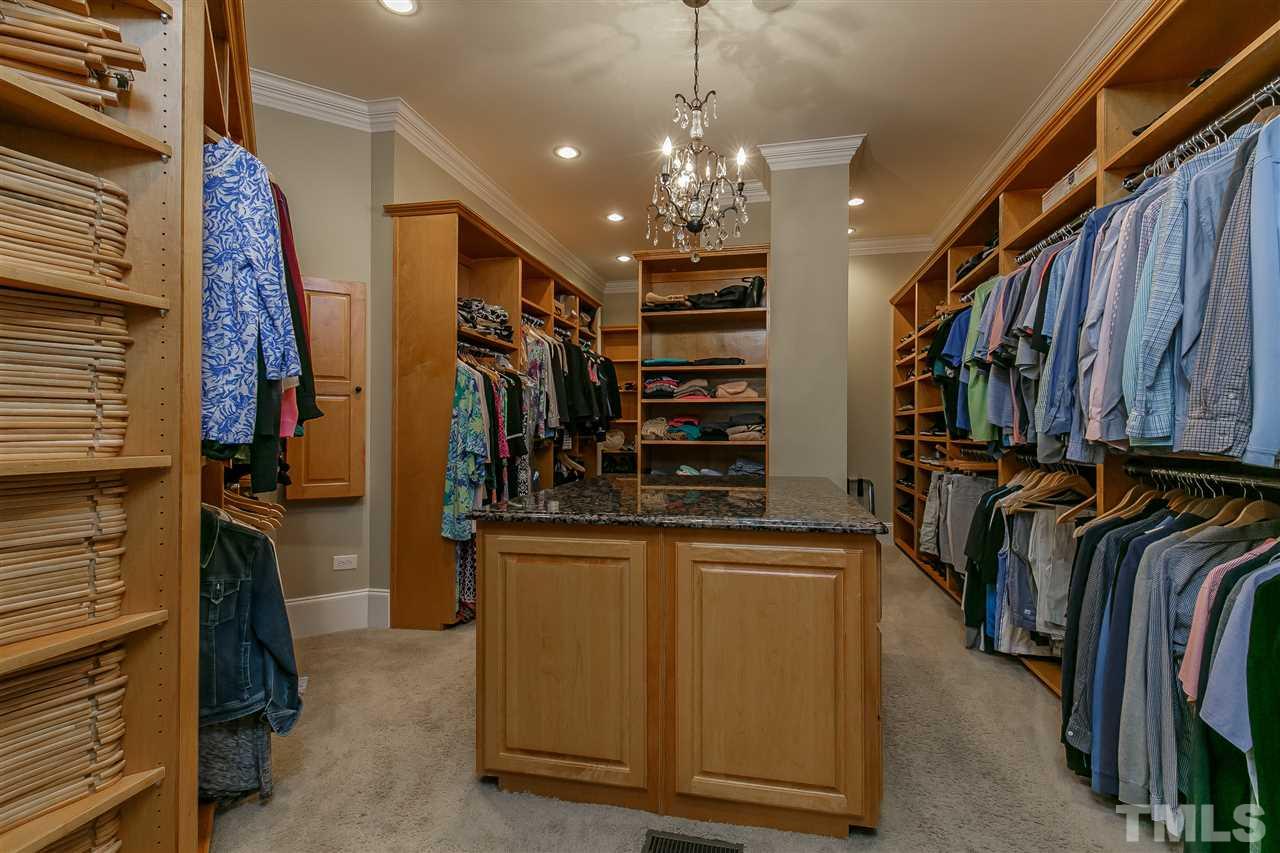 ONE of a KIND custom closet with wood shelving, cubbies, granite storage dresser, shoe rack and built-in ironing board