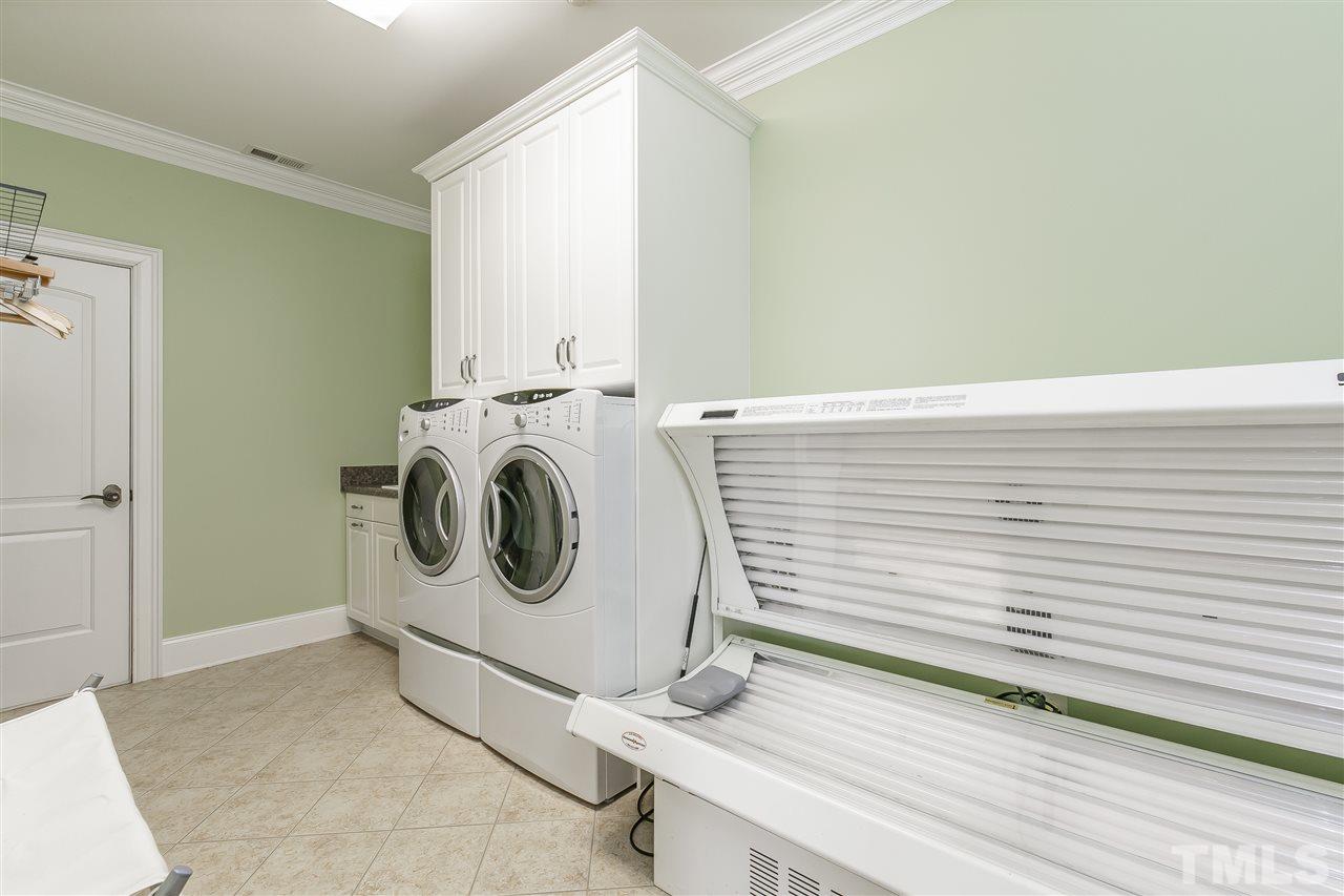 Level 2 laundry with utility sink, upper cabinets and access to LARGE floored attic storage