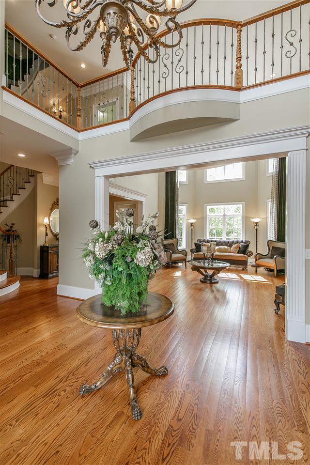 Entry Foyer provides 20.5' ceiling and gleaming hardwoods