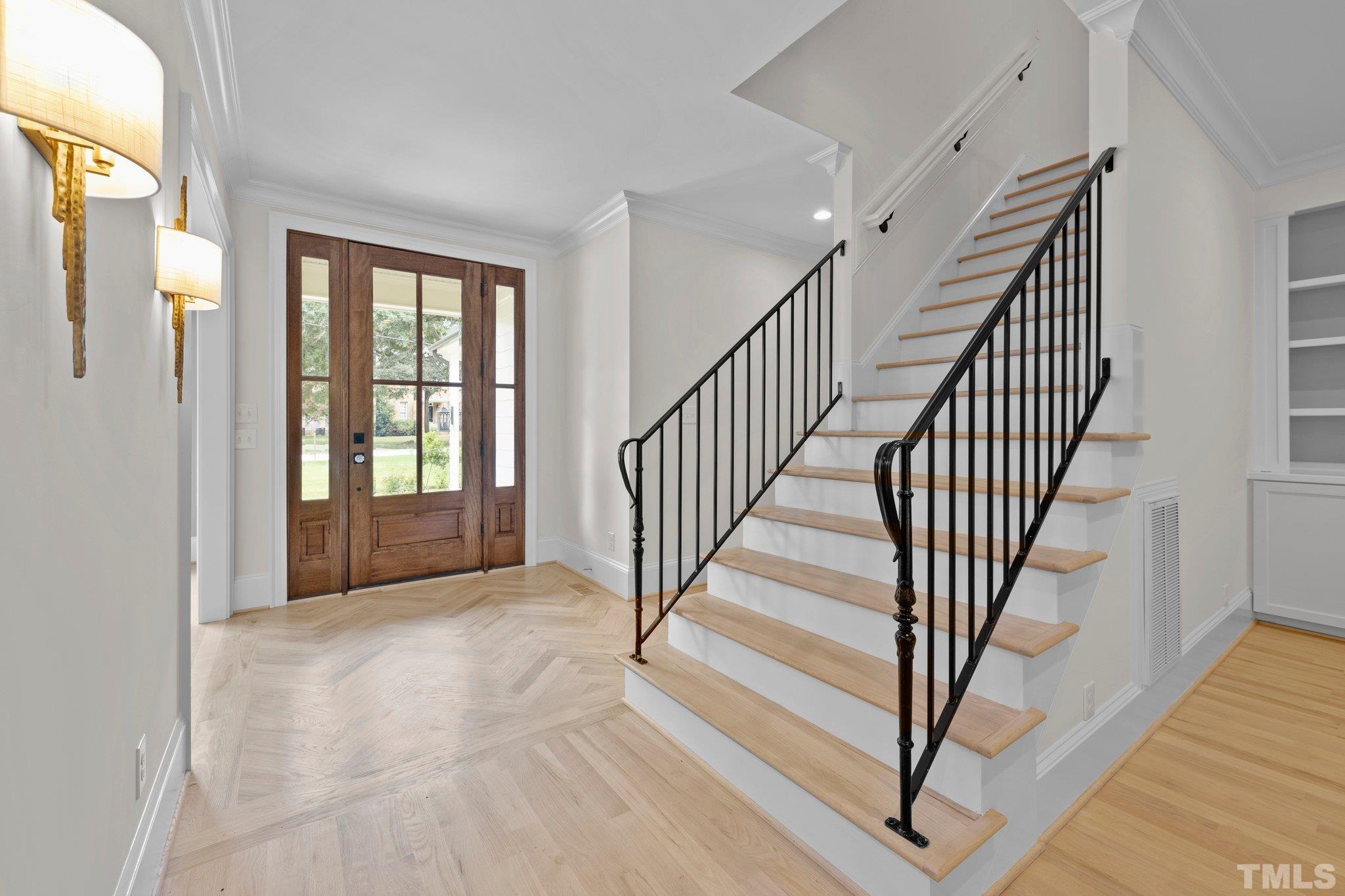 Inviting entry into the foyer with hardwood floors through the 1st floor.