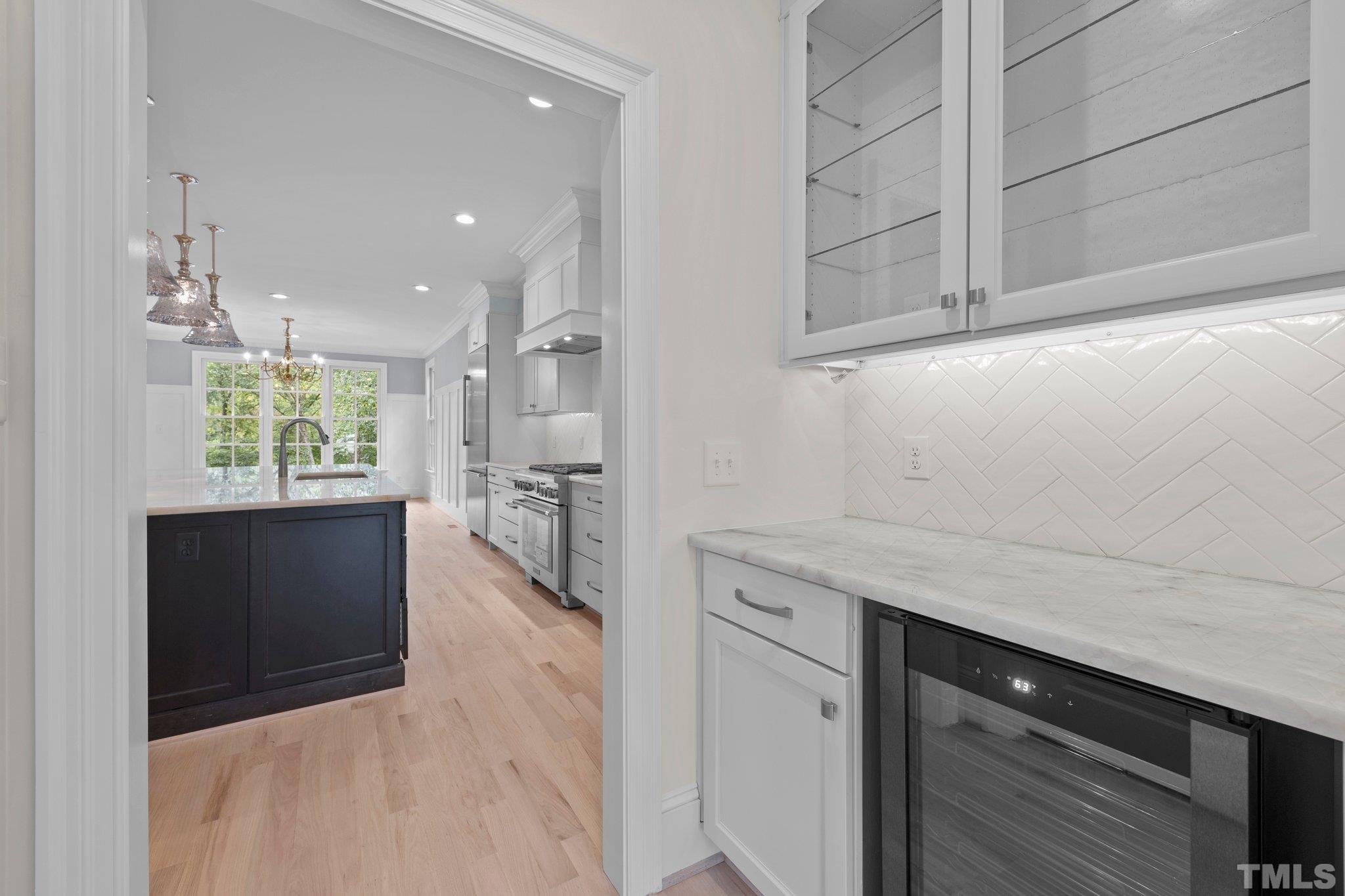 The custom butler's pantry features additional storage for your party favorites featuring a wine cooler. For more storage, you will also find a walk-in dry storage pantry across the way.