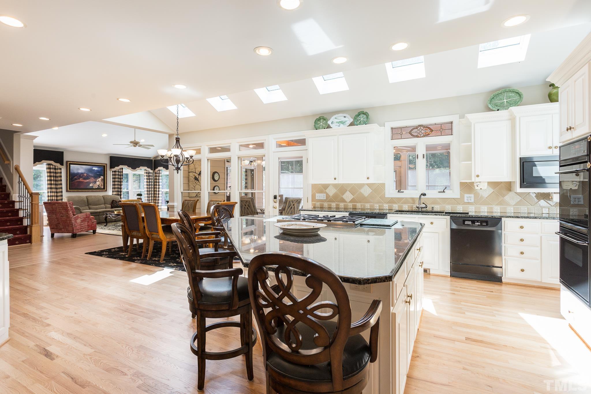 The spacious breakfast room located between the kitchen and family room can easily fit a table to seat 6-8 people.