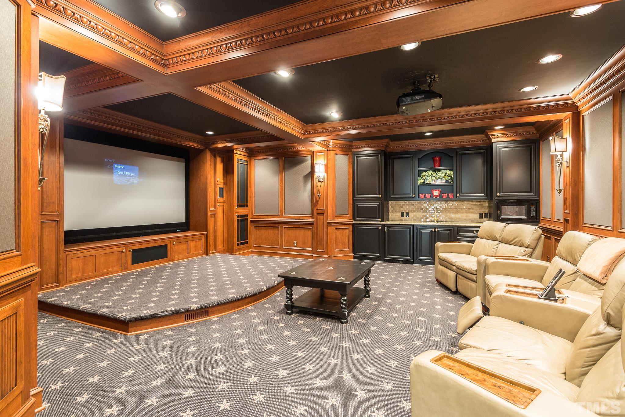 The home theater was part of the 2006 addition.Great care went into its design to include a majestic coffered ceiling. panels for soundproofing, subtle built-in storage for audio-visual components, a built-in home stage, and wet bar w/microwave.