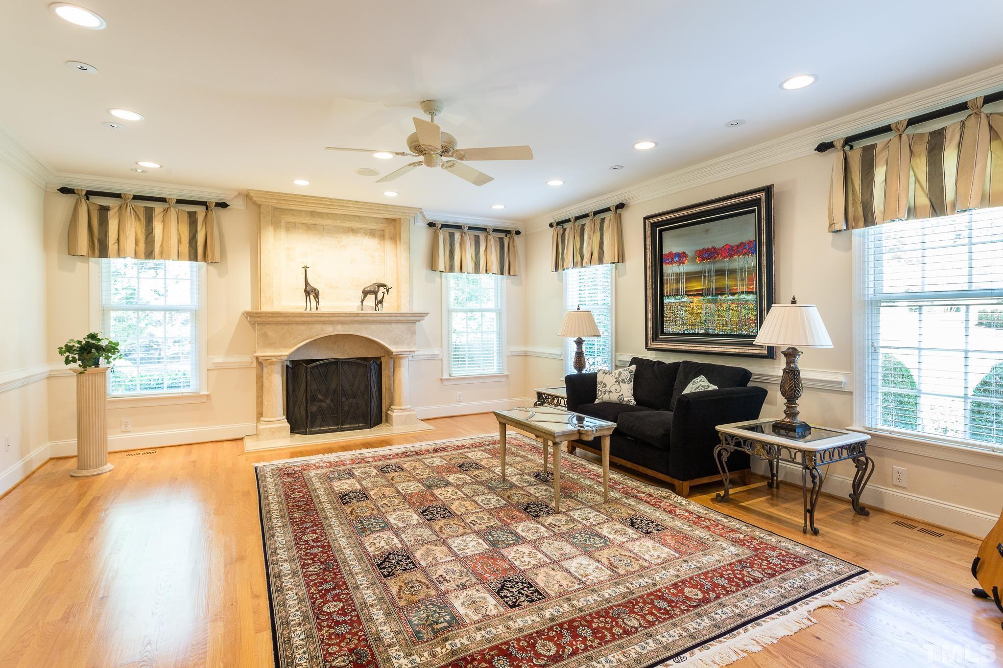 This quite retreat is located in the east wing of the home and was part of the 2006 addition.  This beautiful room has been used as a magnificent home office and a music room. A stately gas fireplace with stone surround is the central feature of the room.