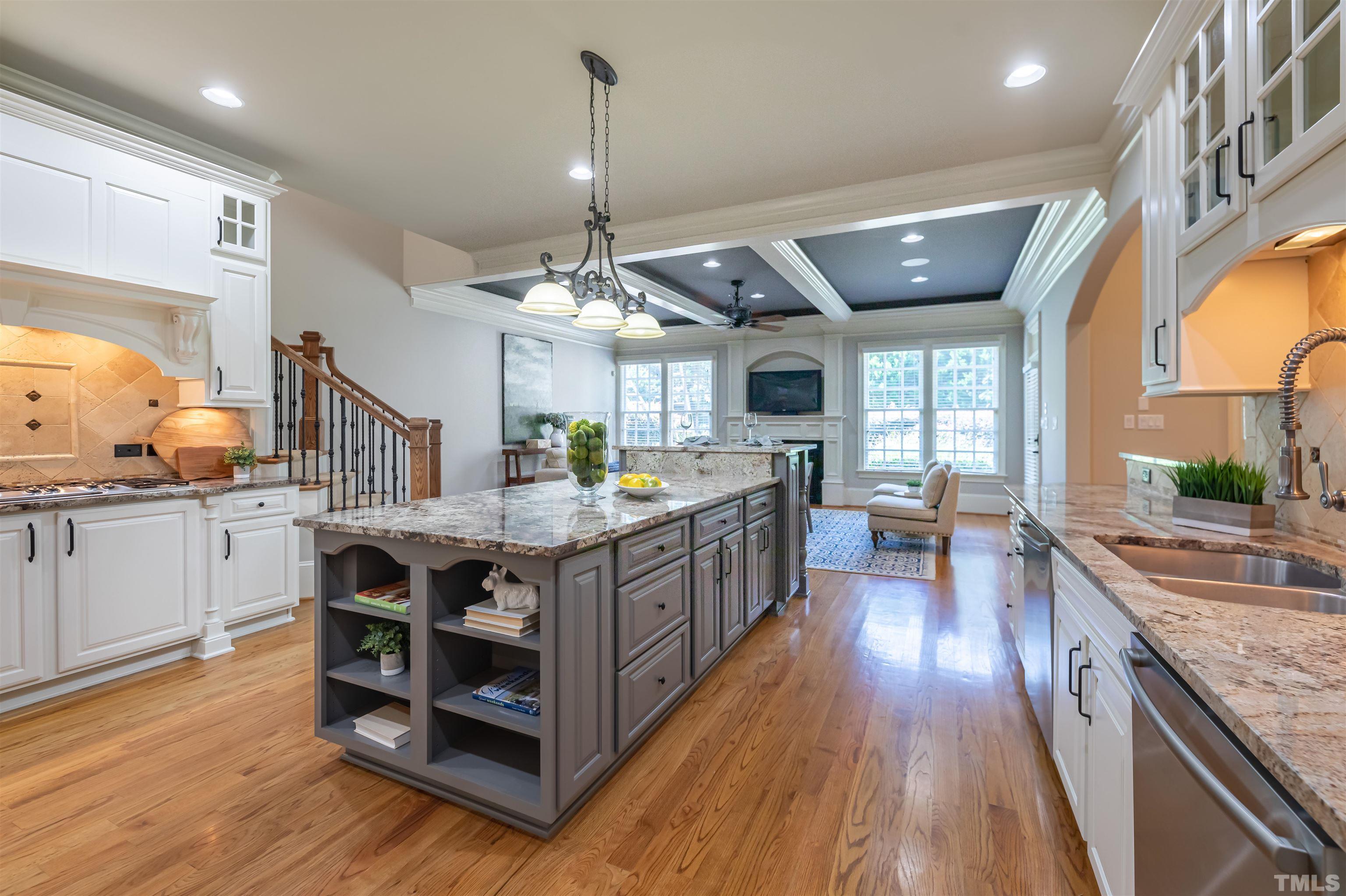 The gourmet kitchen is a cook's delight with professional style Thermador appliances including a six burner gas cook top with down draft, built in oven, microwave & warming drawer, fridge.  There are 2 dishwashers.