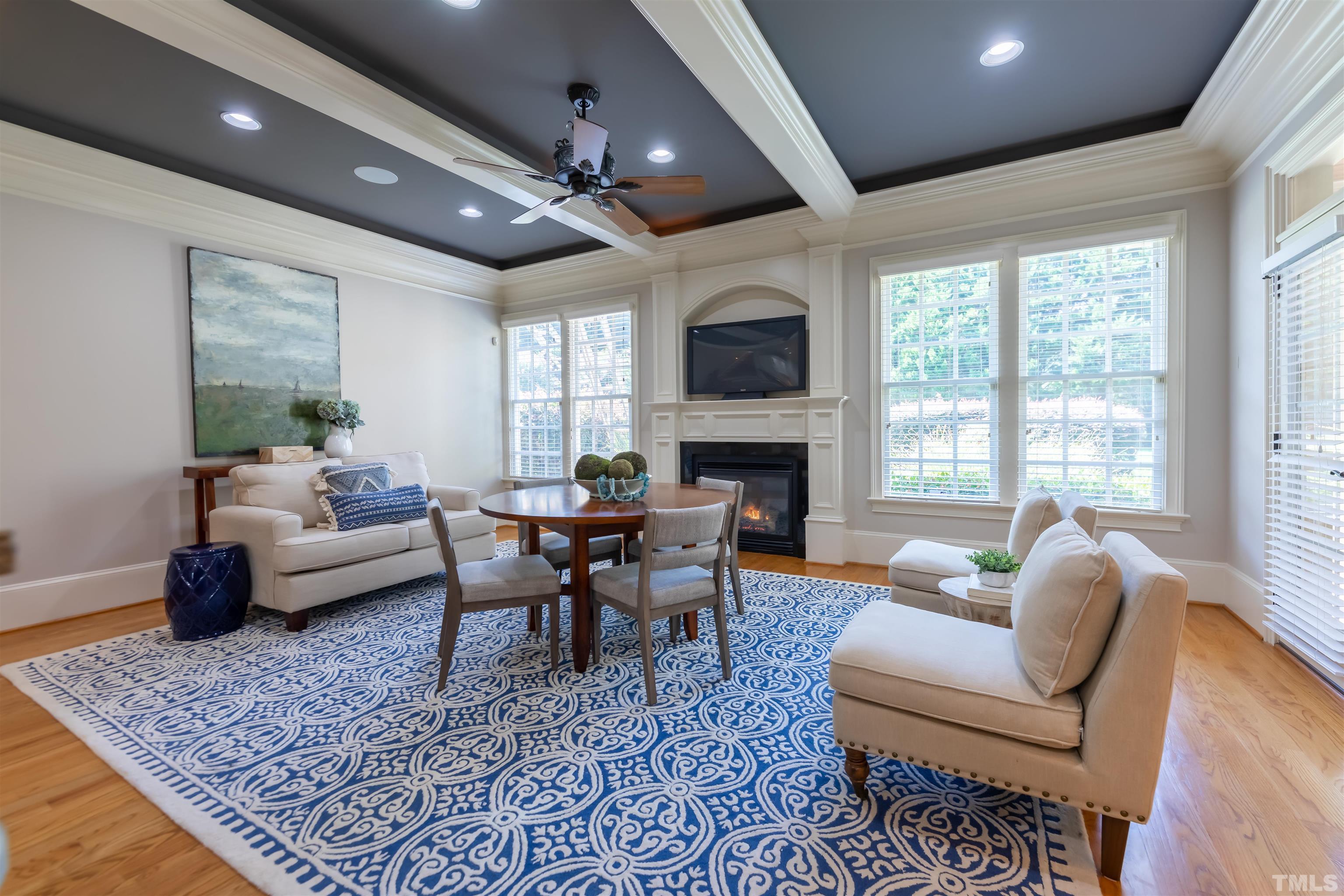 There are so many ways to use this space...a breakfast room, keeping room or a combination.  The beamed ceiling also has up-lighting as well as recessed.  There is room for a TV above the fireplace.  Gather and socialize with the cooks in the kitchen.