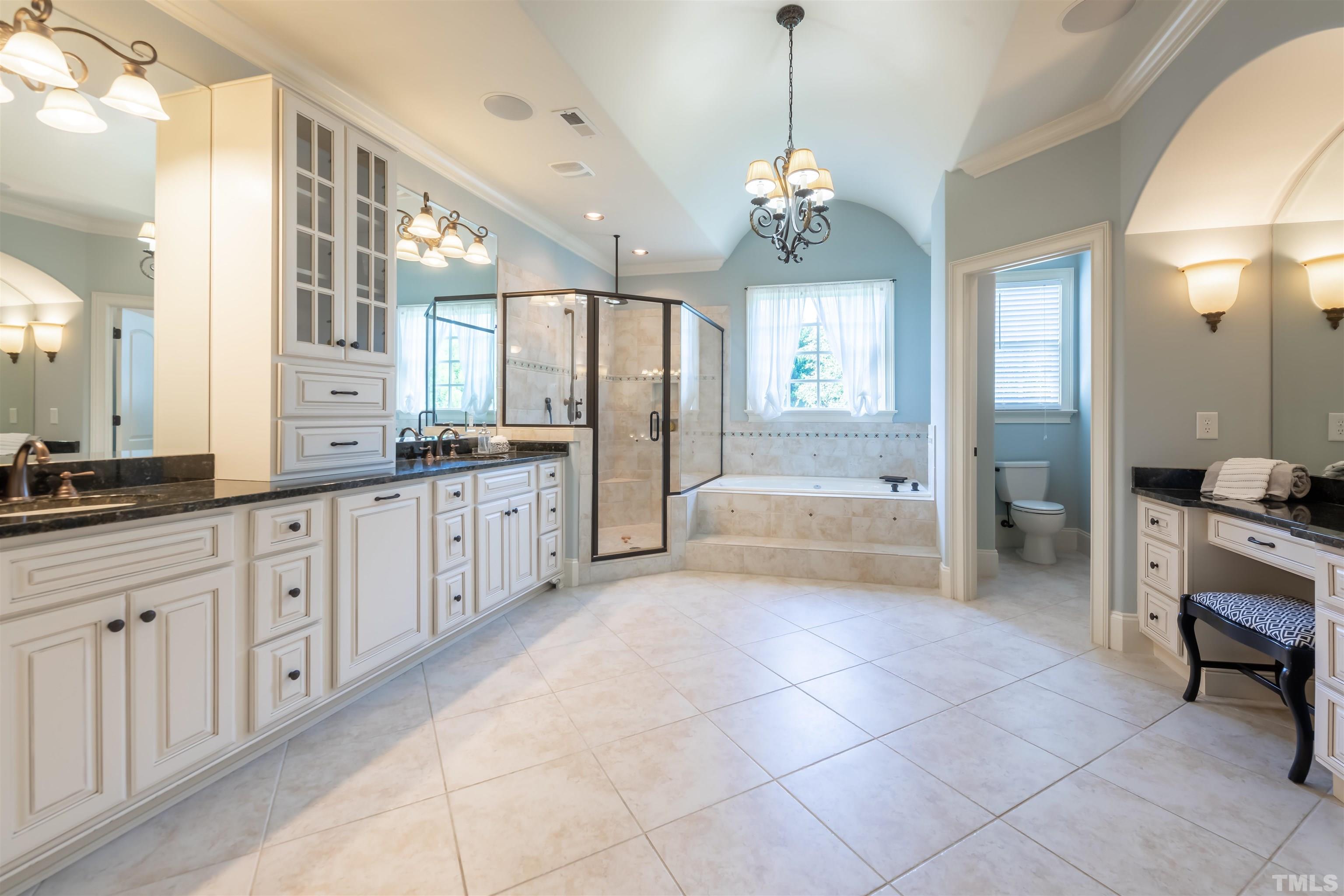 The spa-like master bath is luxurious and functional.  A large vanity with 2 sinks is divided with extra cabinetry.  There is a large walk in shower with rainhead as well as a shower arm.   The whirlpool tub is the place to relax at the end of the day.