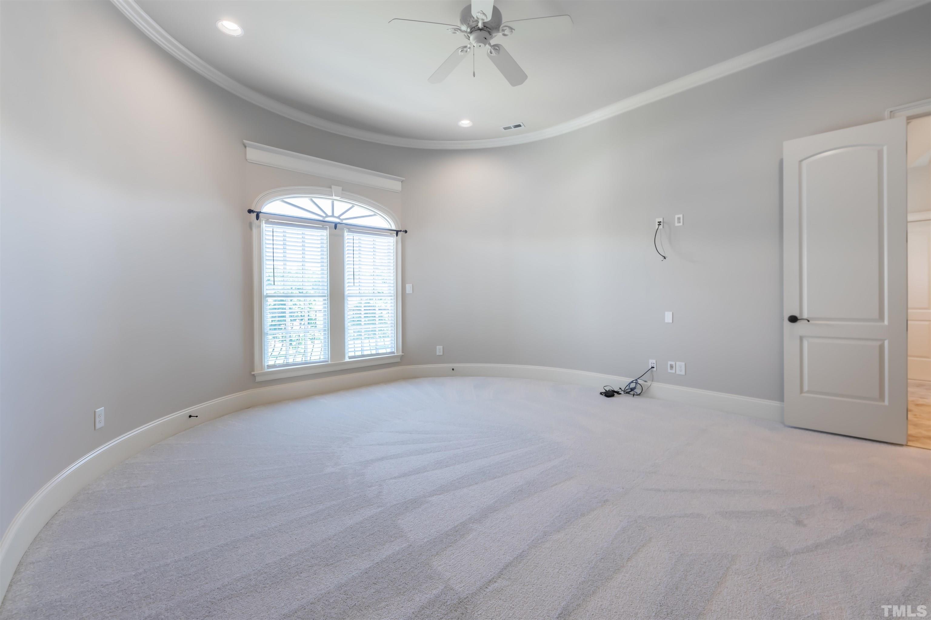 The secondary bedrooms are really large.  This front bedroom sits above the dining room and follows the curved wall of the turret.  High ceilings, crown molding, new carpet.  It has a large walk in closet and private bath.