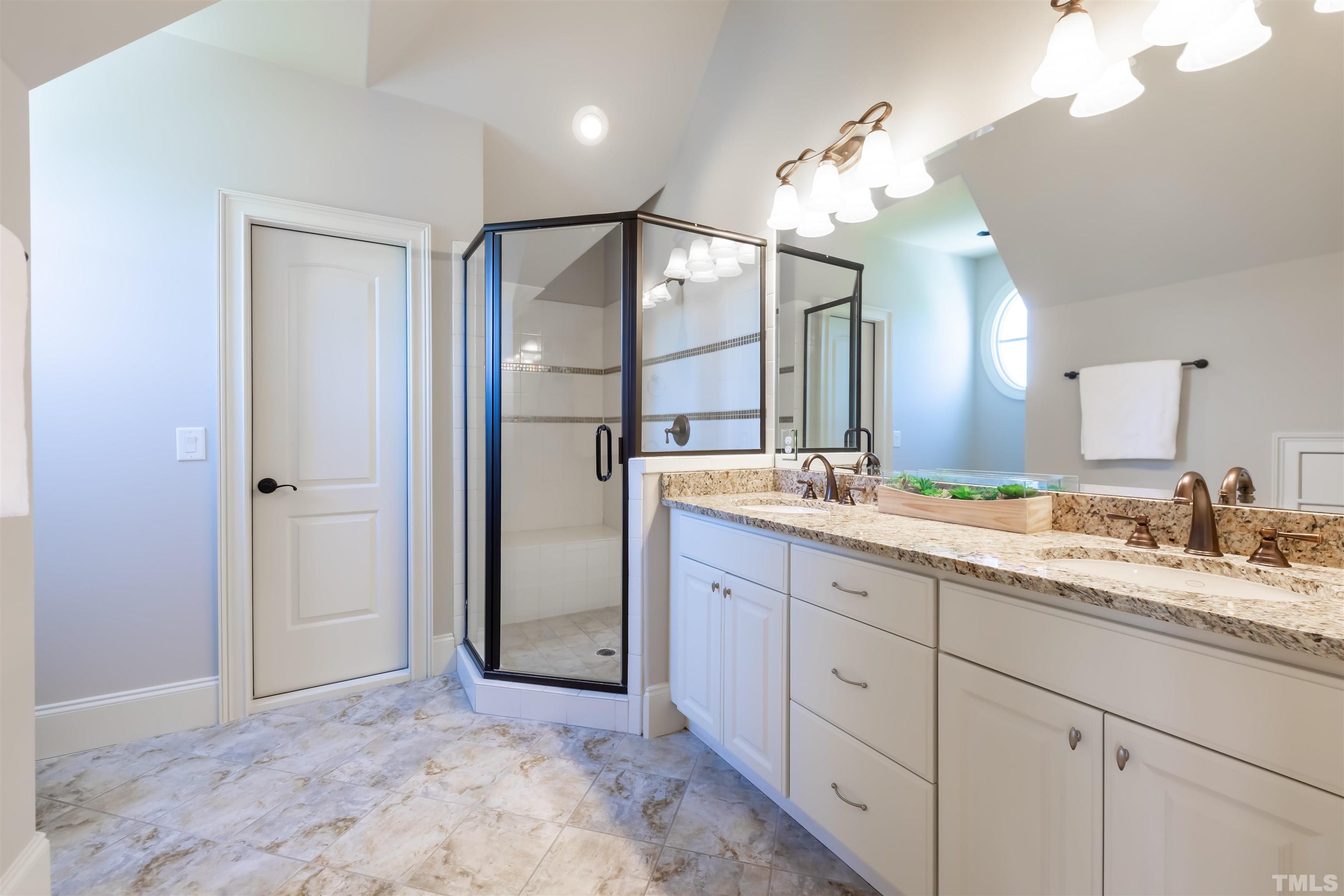 The bathroom to the front bedroom has a walk in shower.  The bathroom to the back bedroom has a tub/shower combo and can be accessed from the bedroom or the hall.
